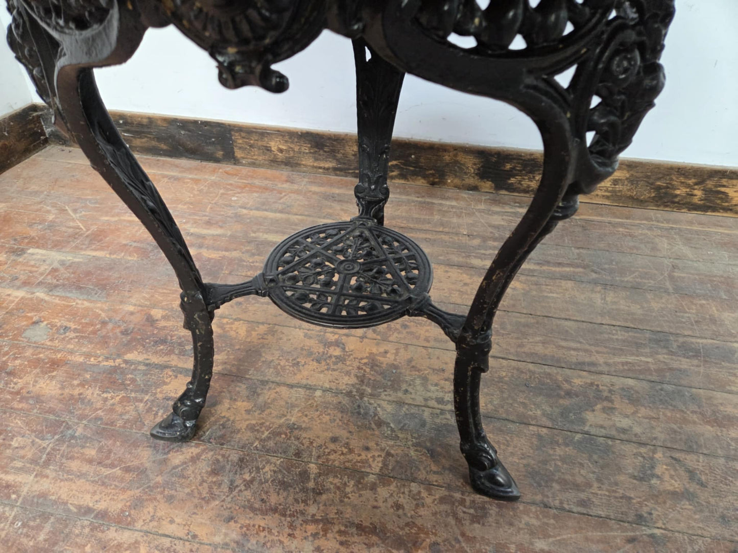 Medium Round Dining Table with Ornate Cast Iron Base and Light Wood Top