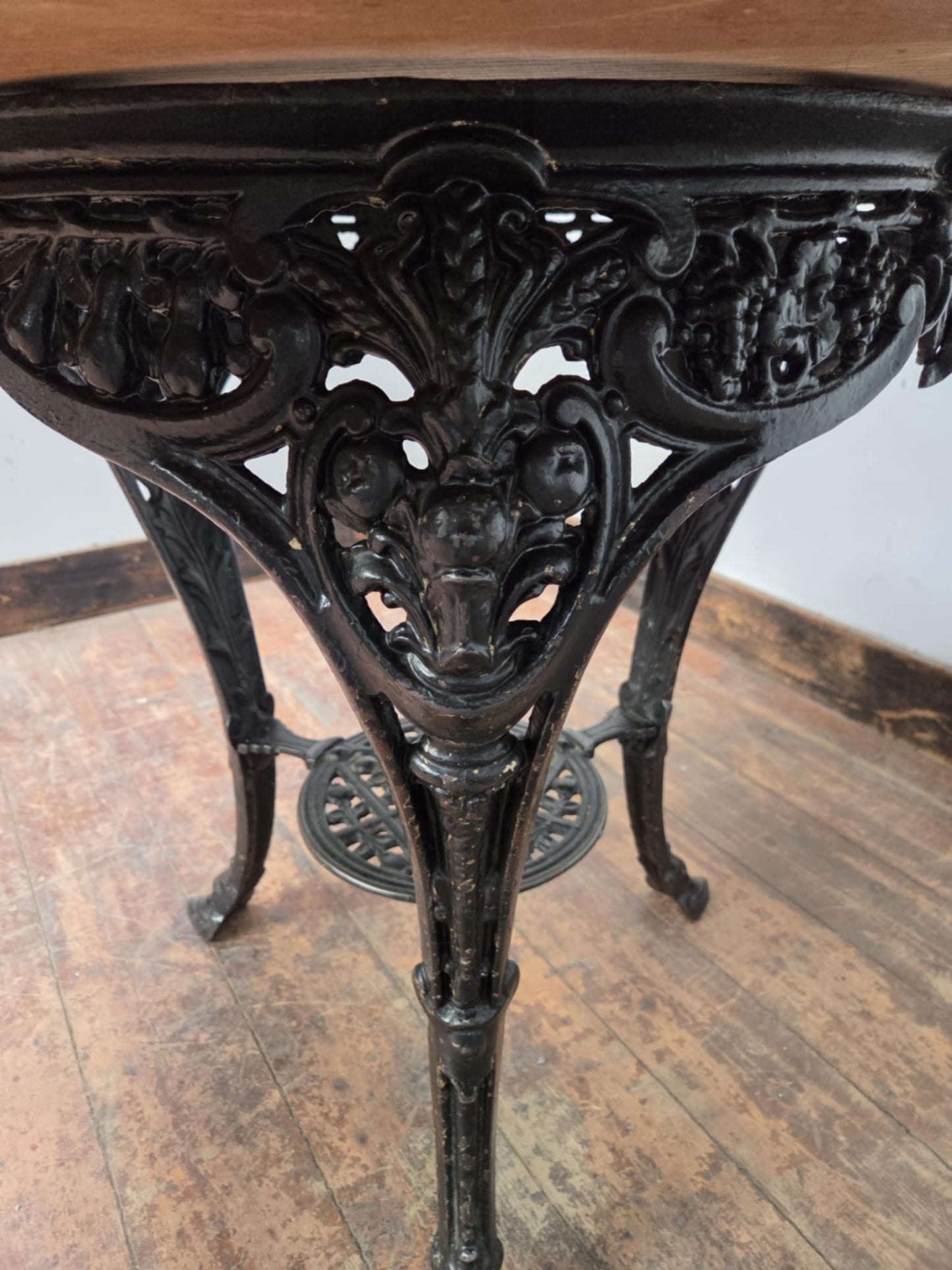Medium Round Dining Table with Ornate Cast Iron Base and Light Wood Top