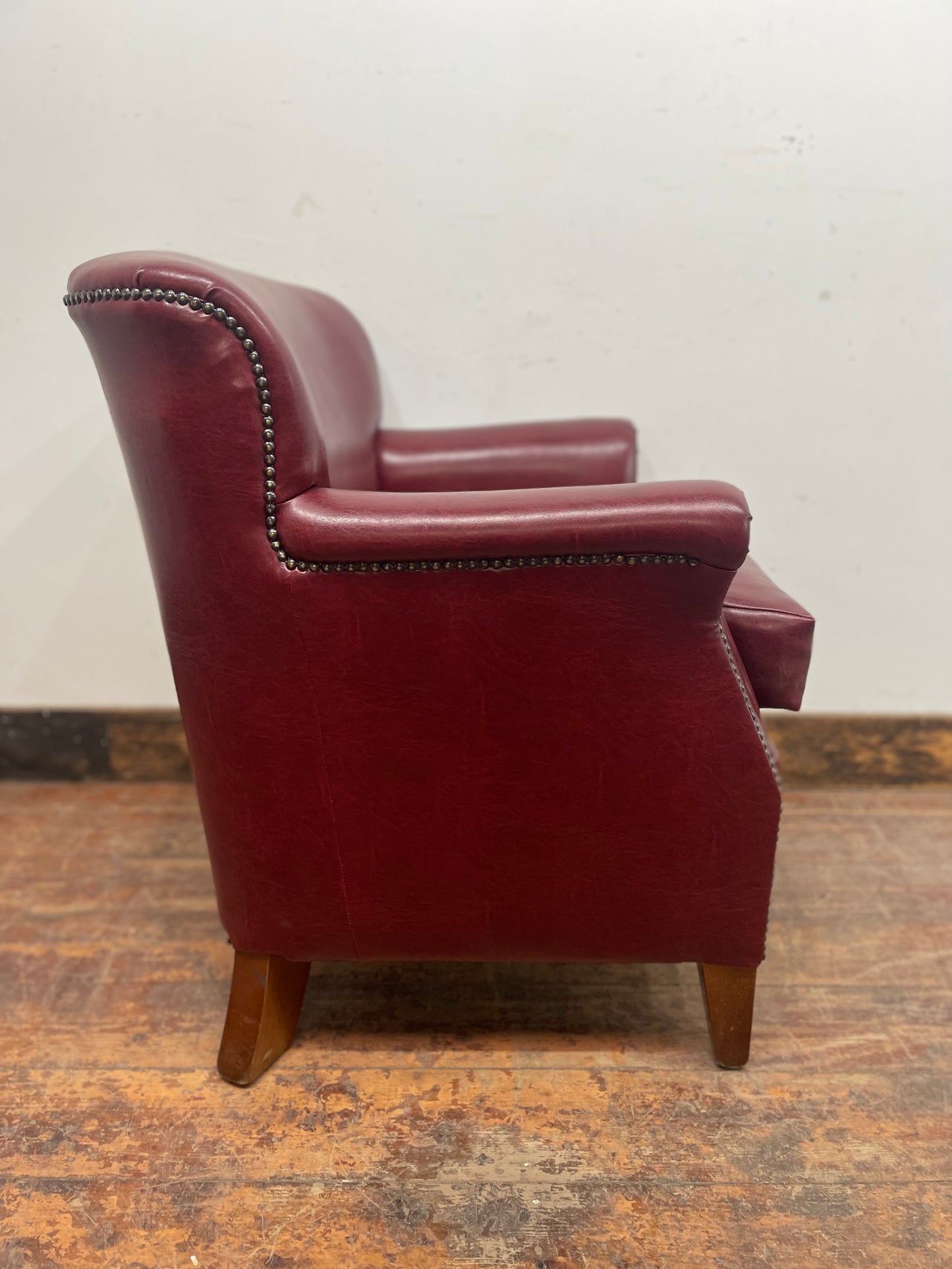 Retro style red leather-effect armchair