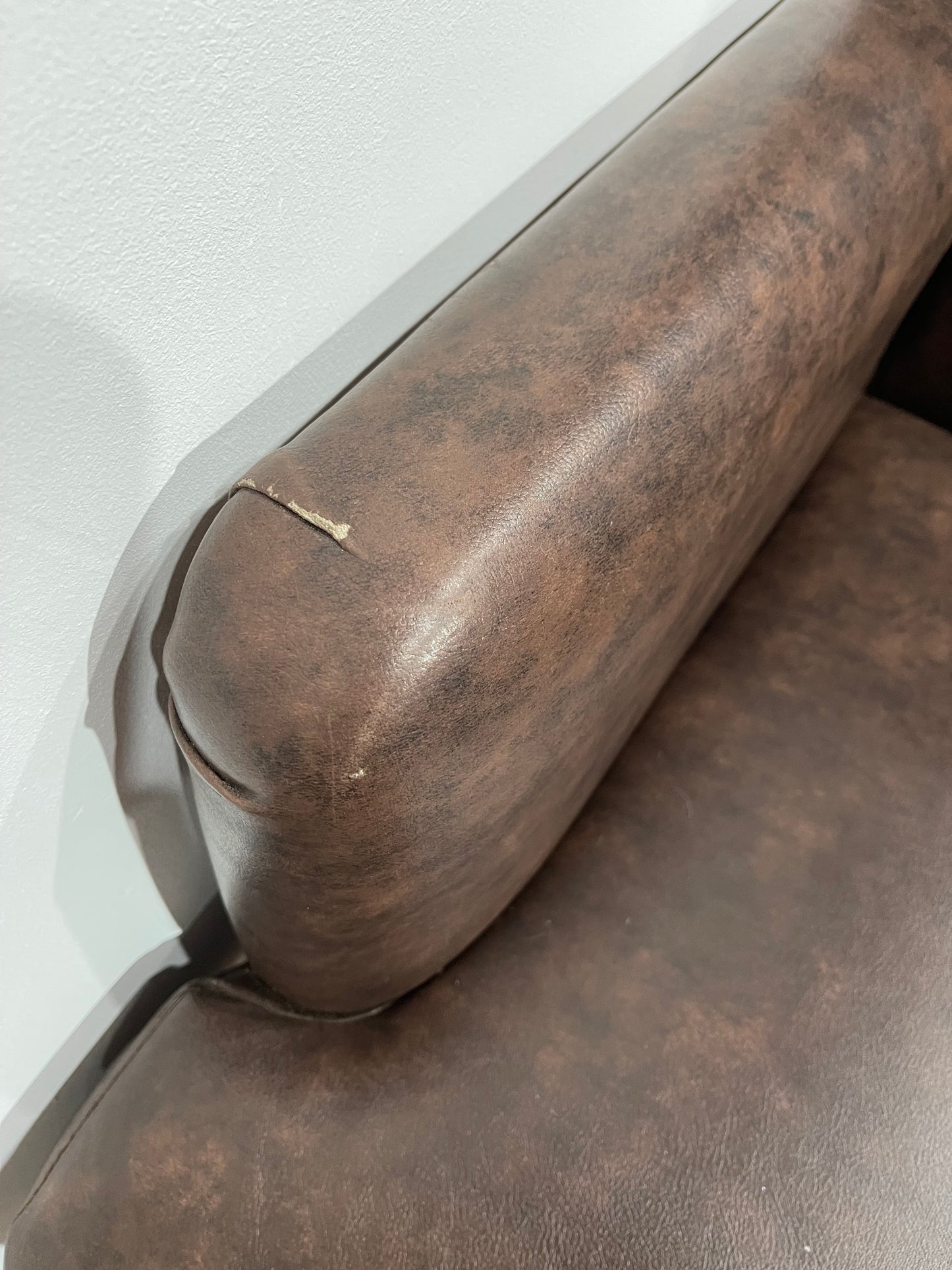 Matching pair of brown faux-leather armchairs