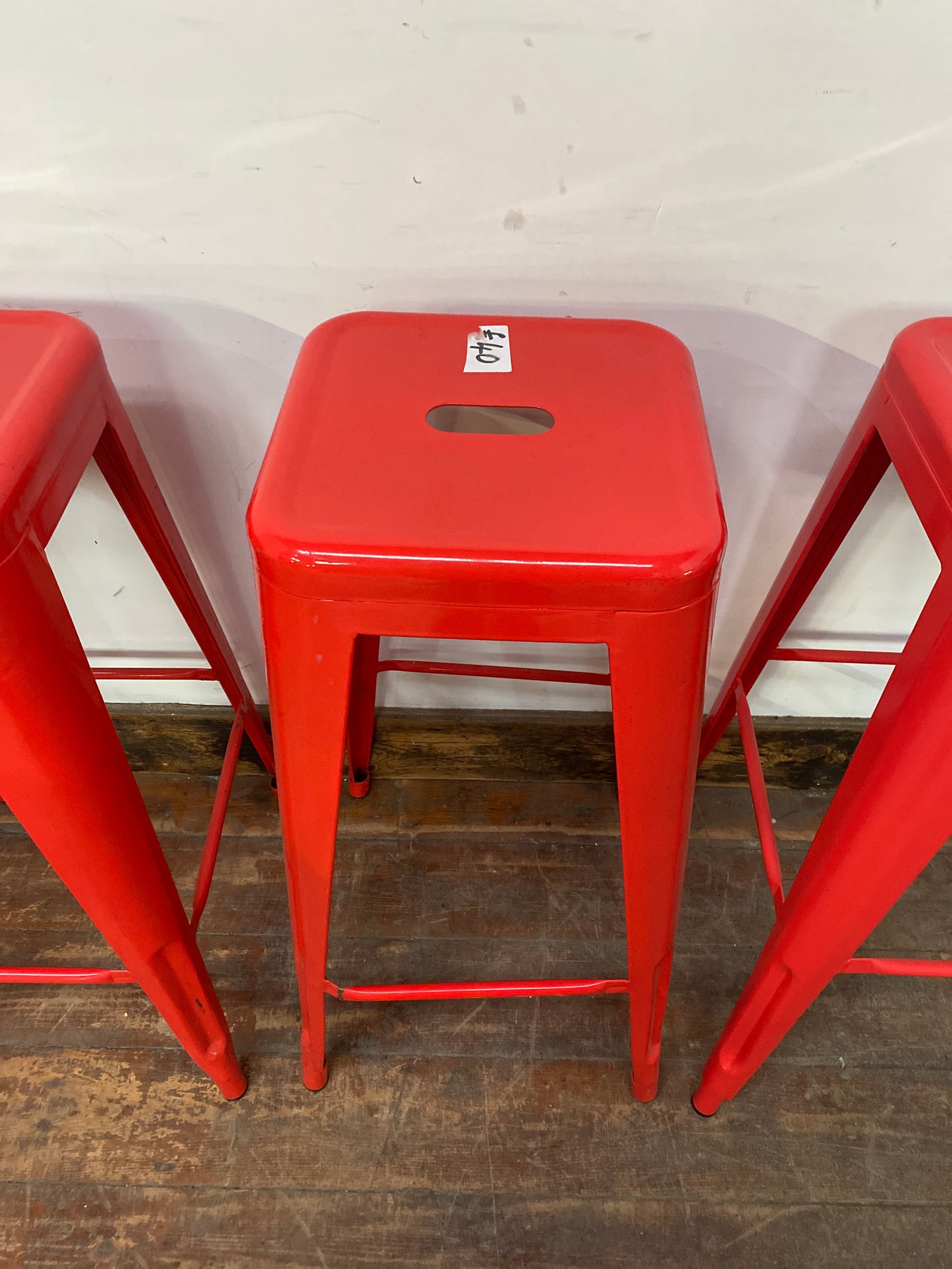 4 red metal stools