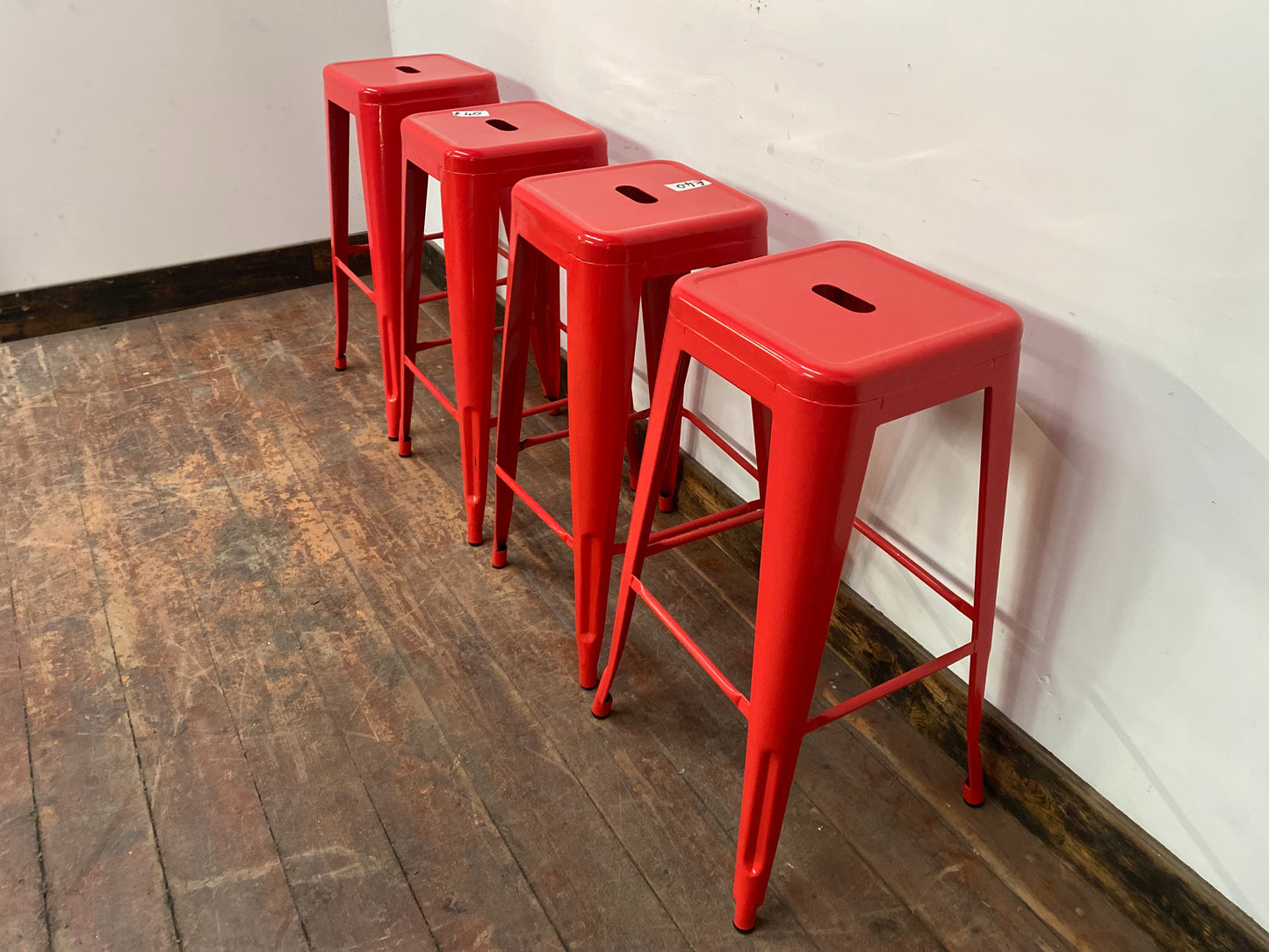 4 red metal stools