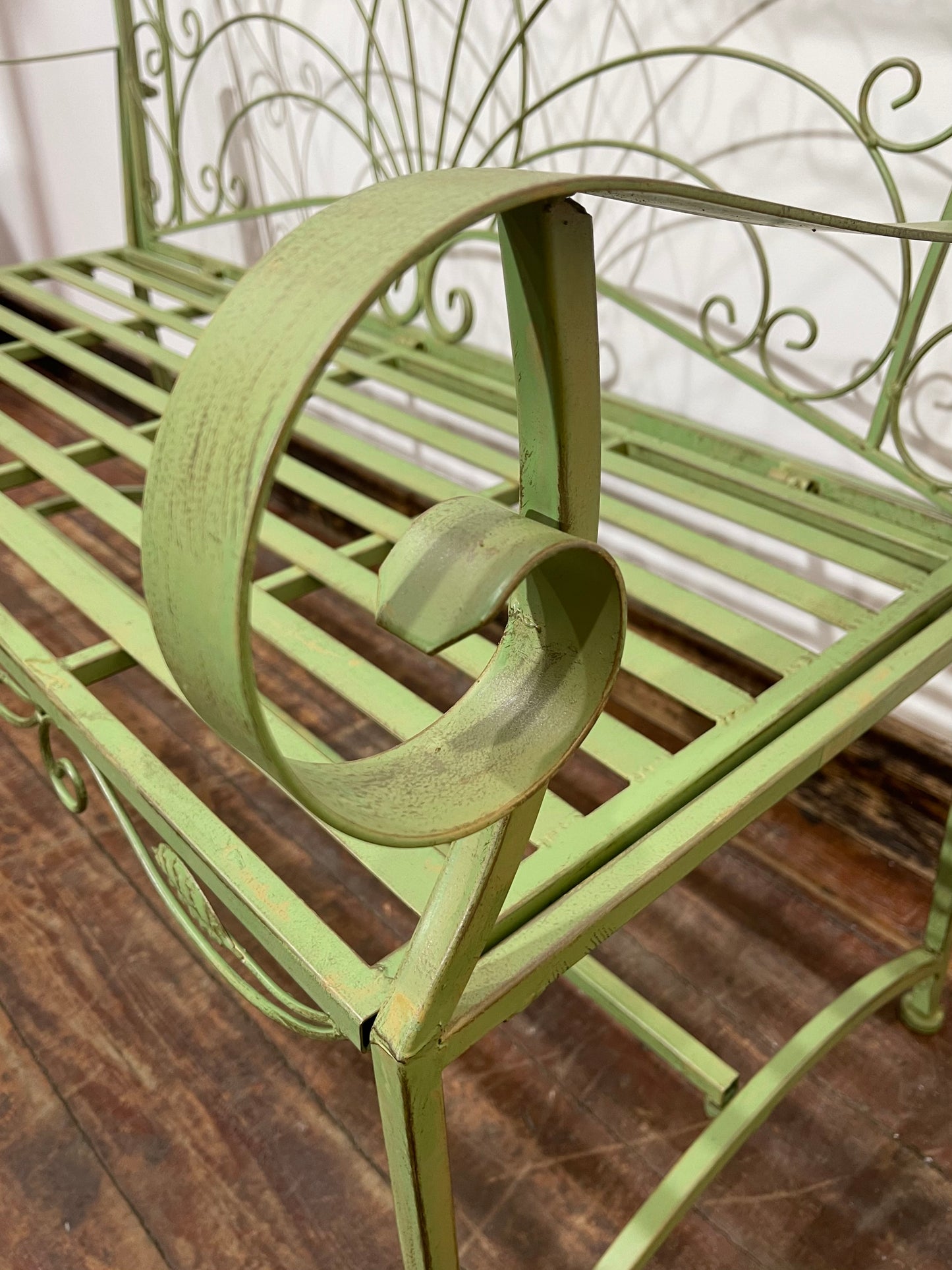 Ornate garden bench in green painted metal