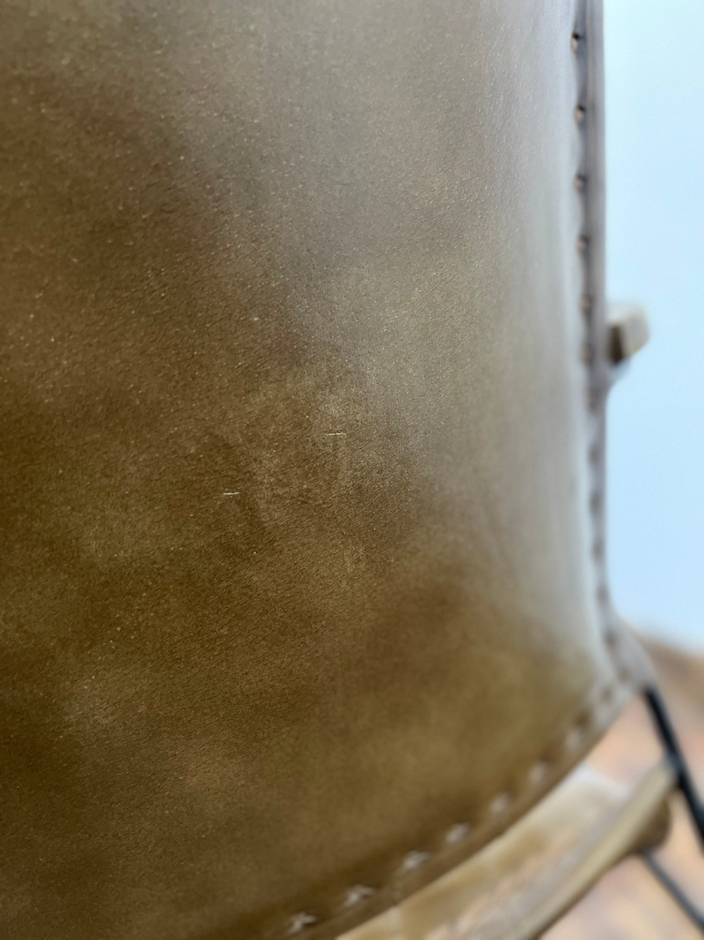 Pair of tan leather armchairs with metal frame