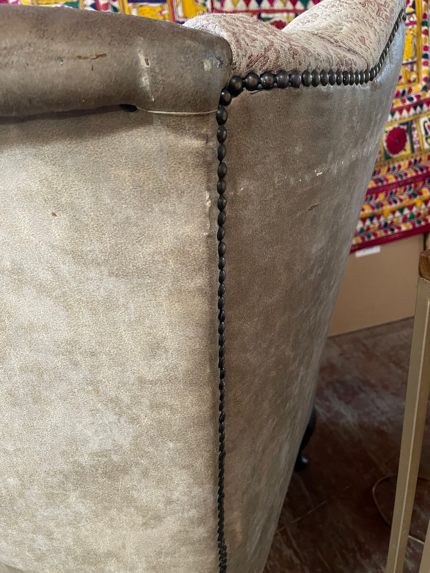 Grey wingback armchair with patterned fabric backrest