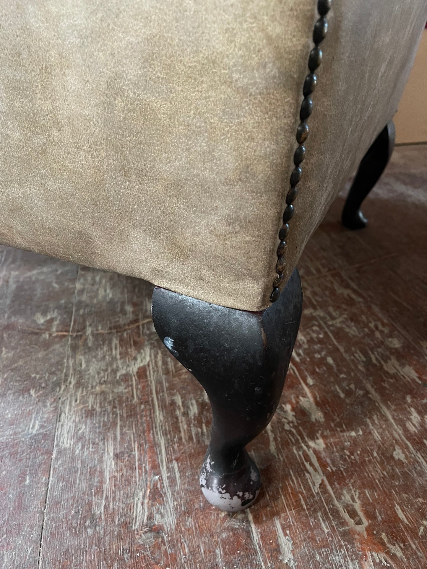 Grey wingback armchair with patterned fabric backrest