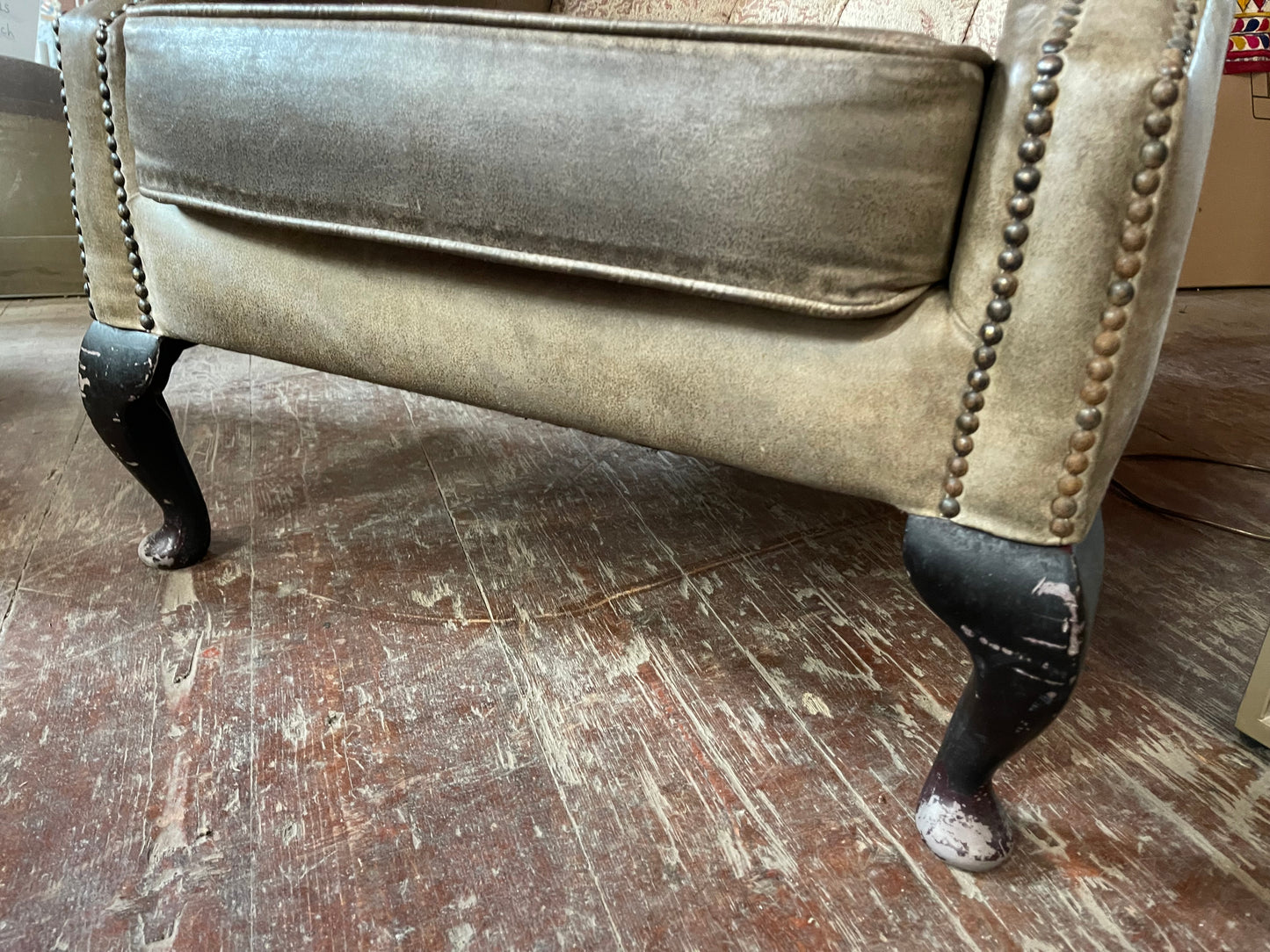 Grey wingback armchair with patterned fabric backrest