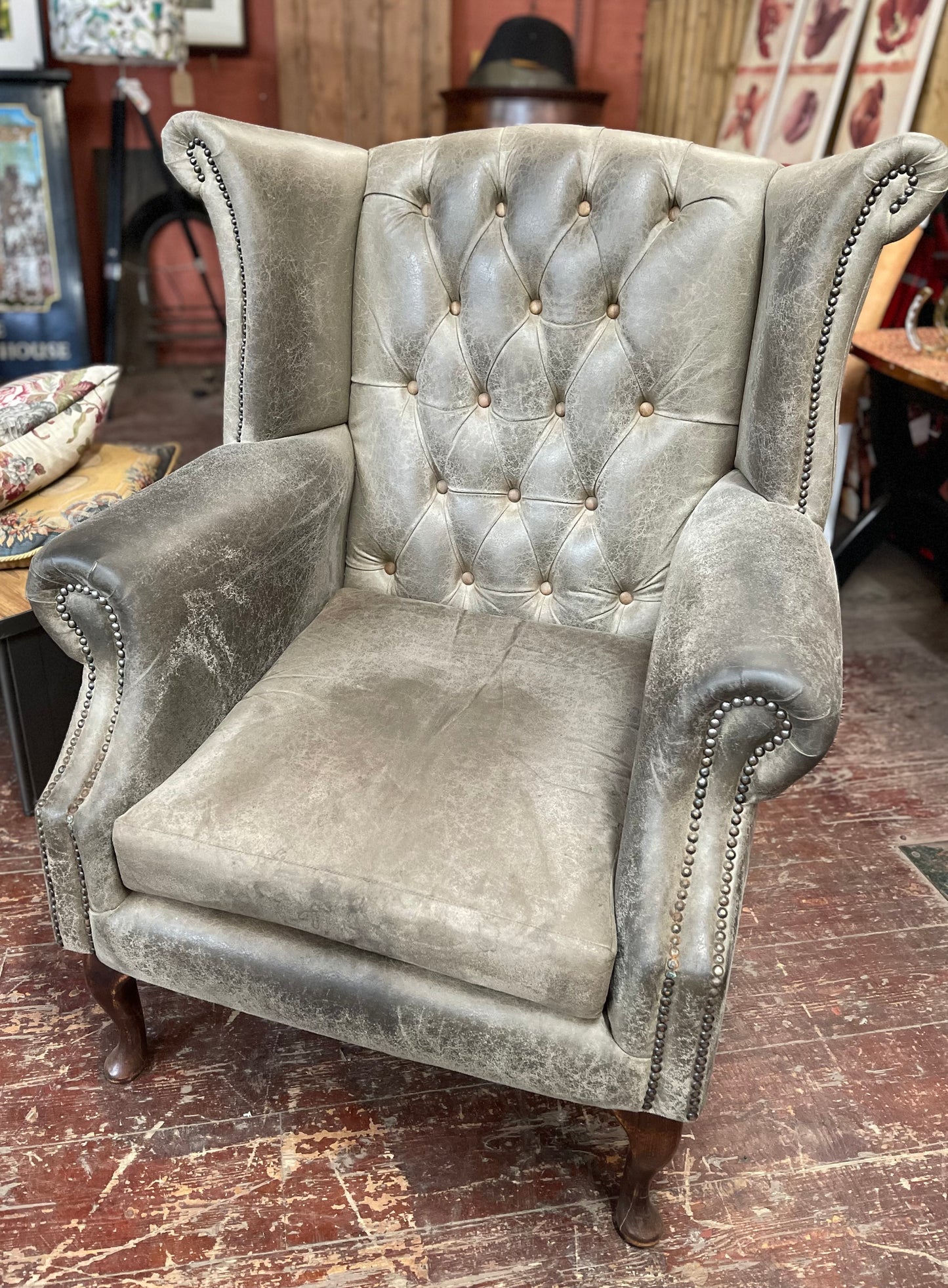 Grey Chesterfield style wingback armchair
