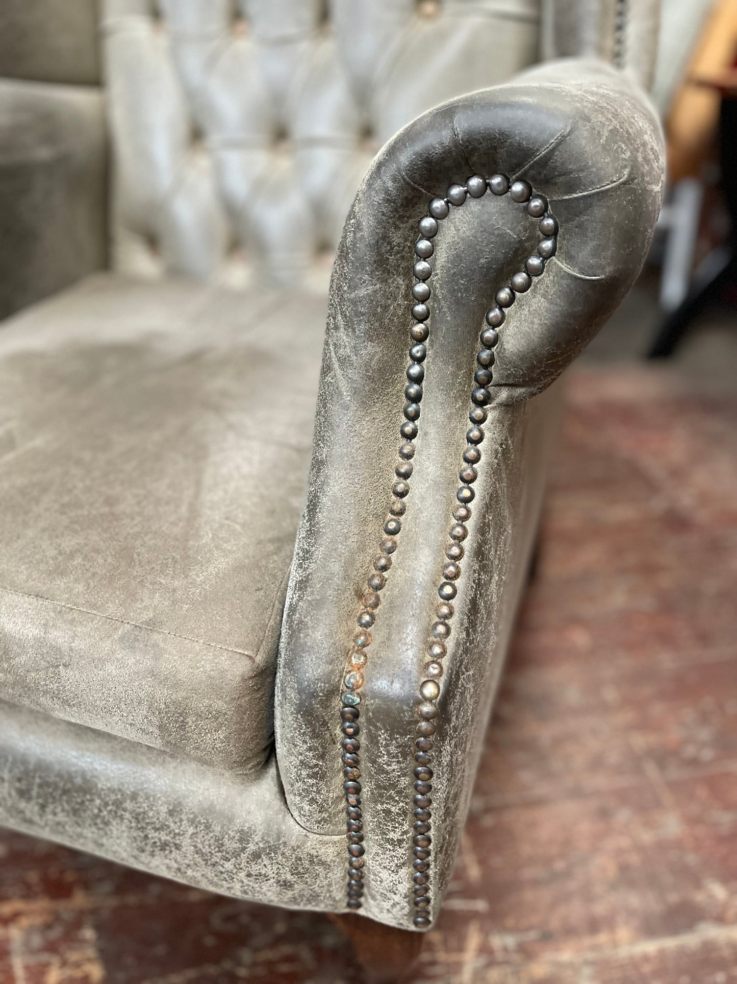 Grey Chesterfield style wingback armchair