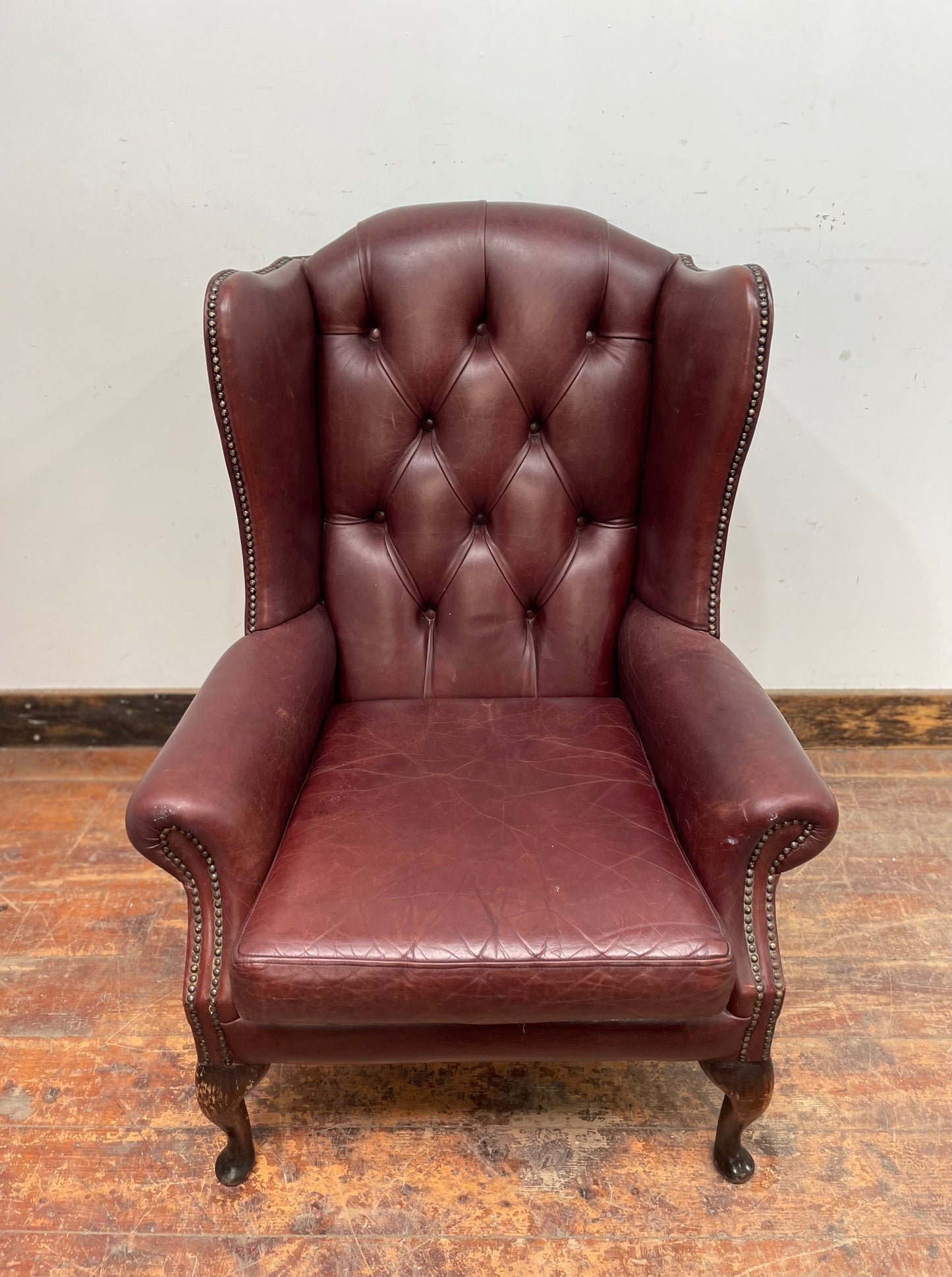 Dark red / oxblood leather wingback armchair