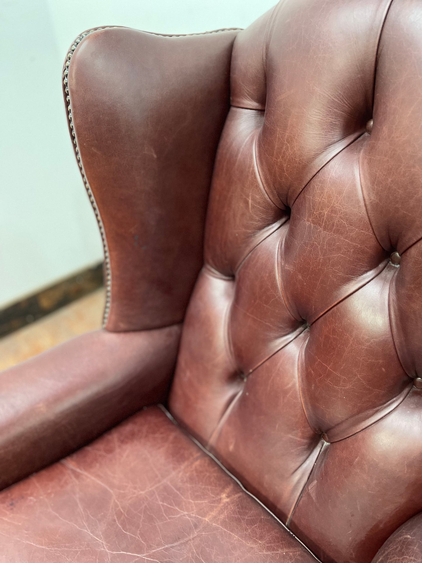 Dark red / oxblood leather wingback armchair