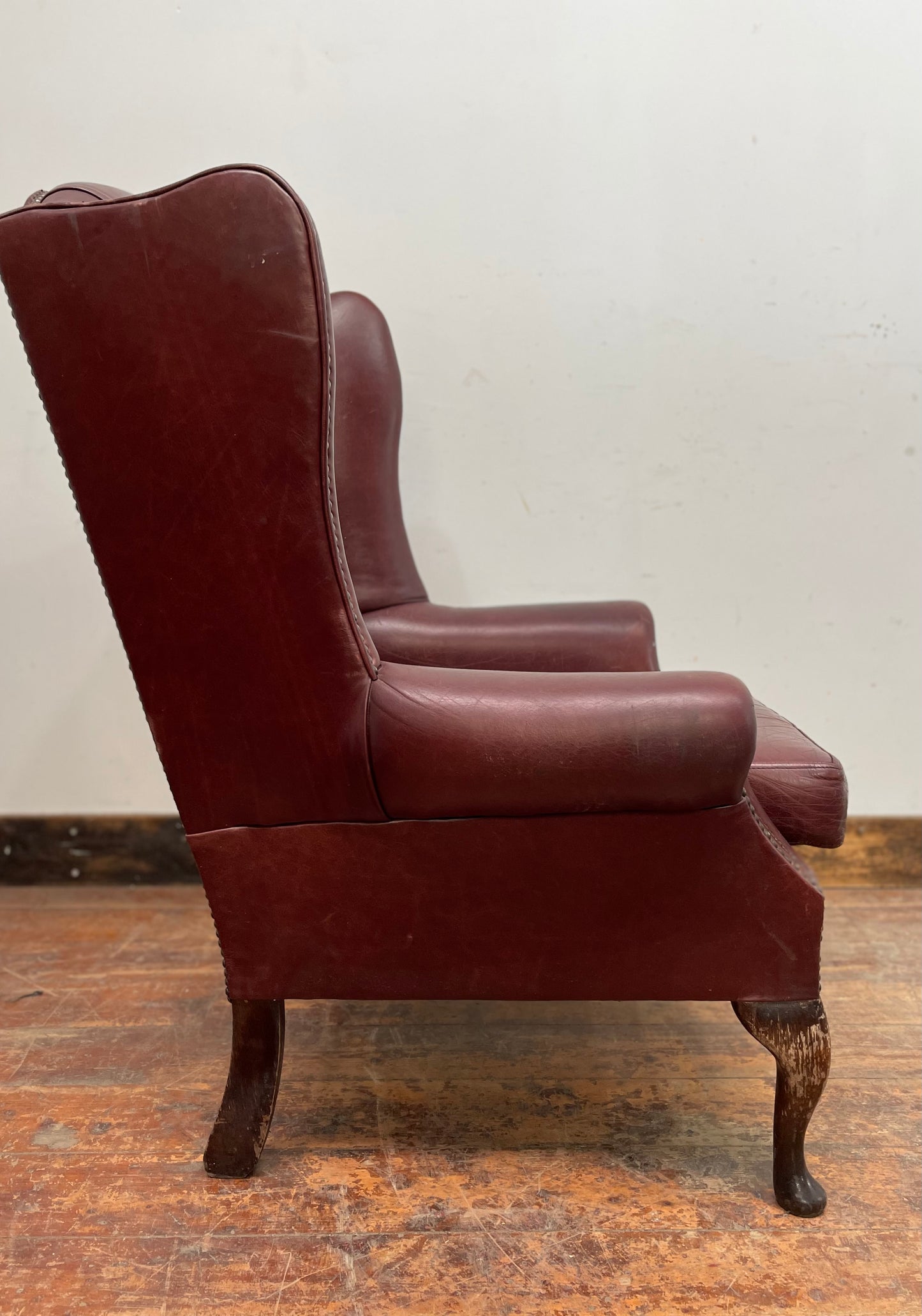 Dark red / oxblood leather wingback armchair