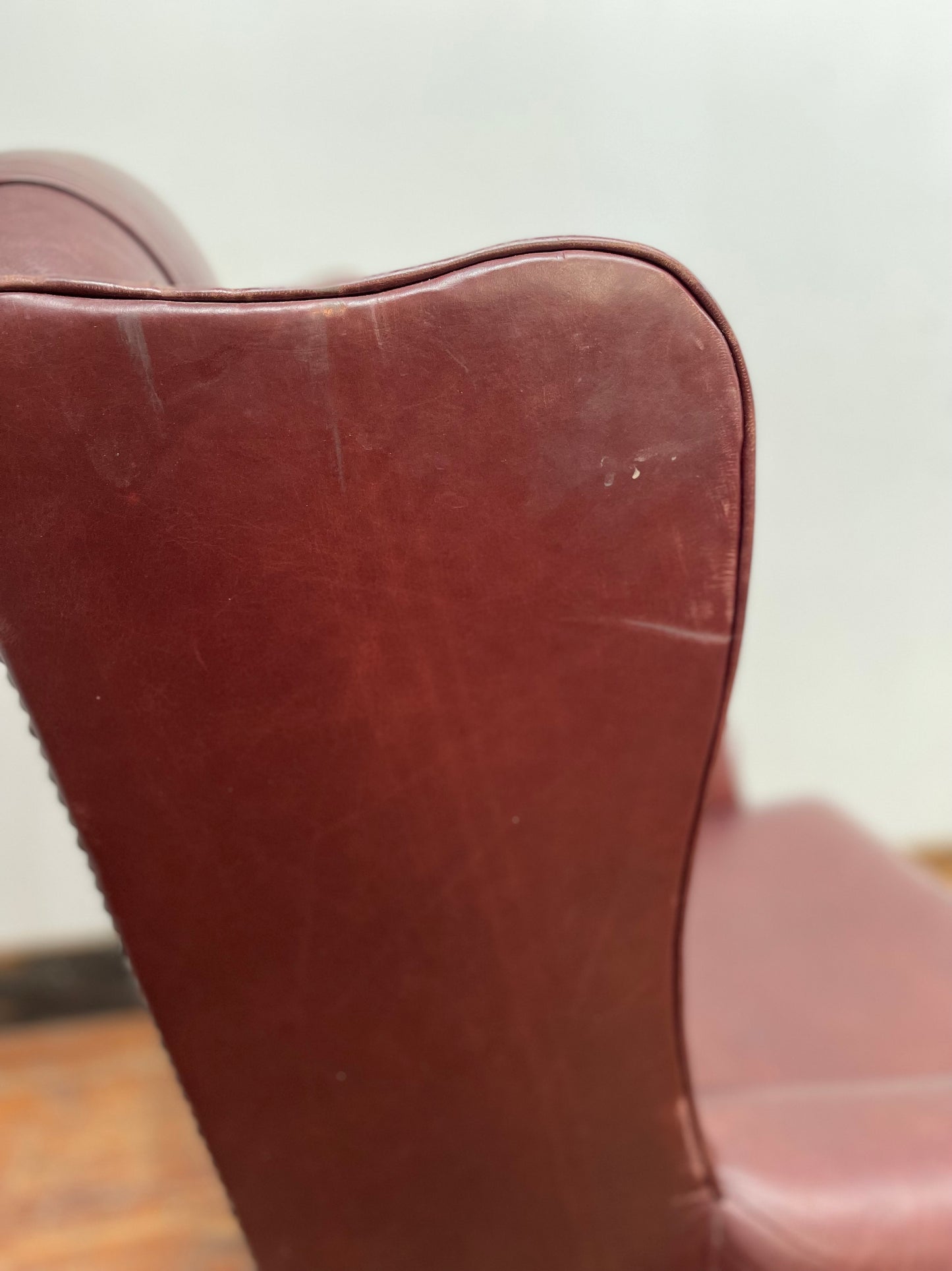 Dark red / oxblood leather wingback armchair