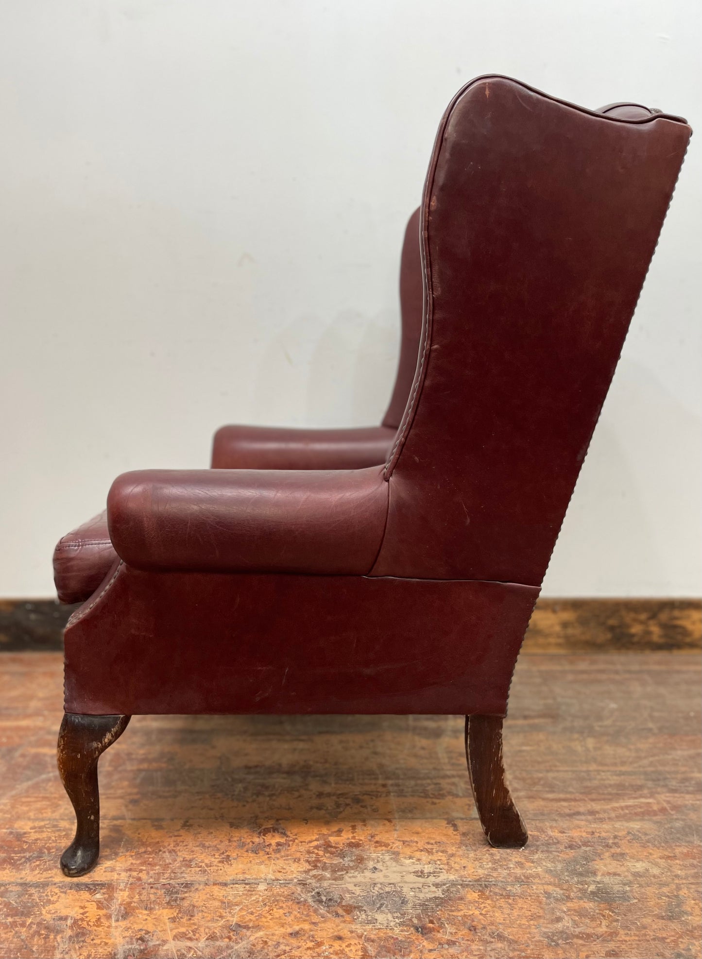 Dark red / oxblood leather wingback armchair