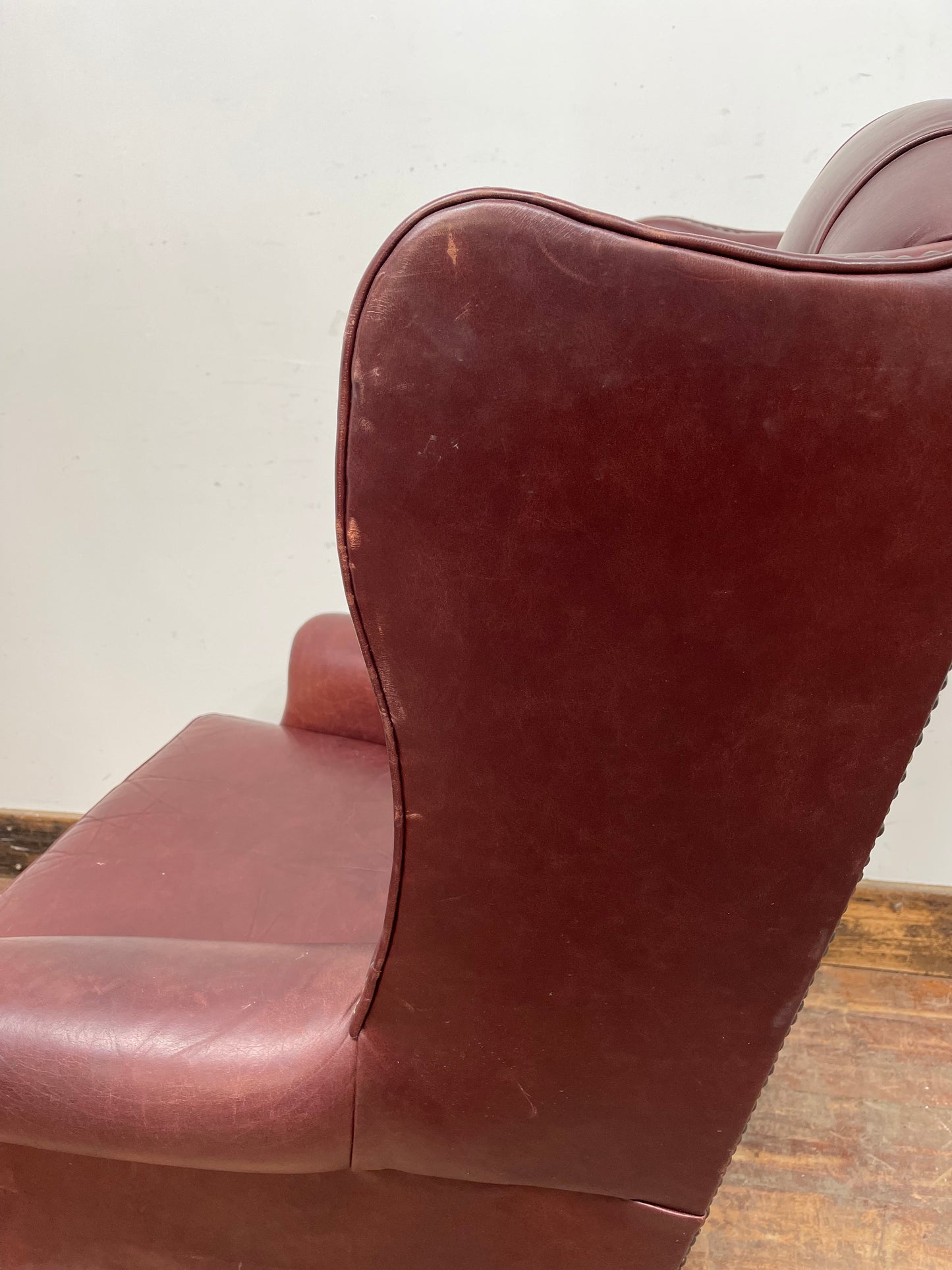 Dark red / oxblood leather wingback armchair
