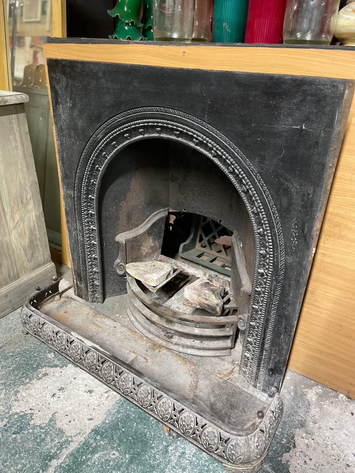 Old cast iron fireplace with decorative fender