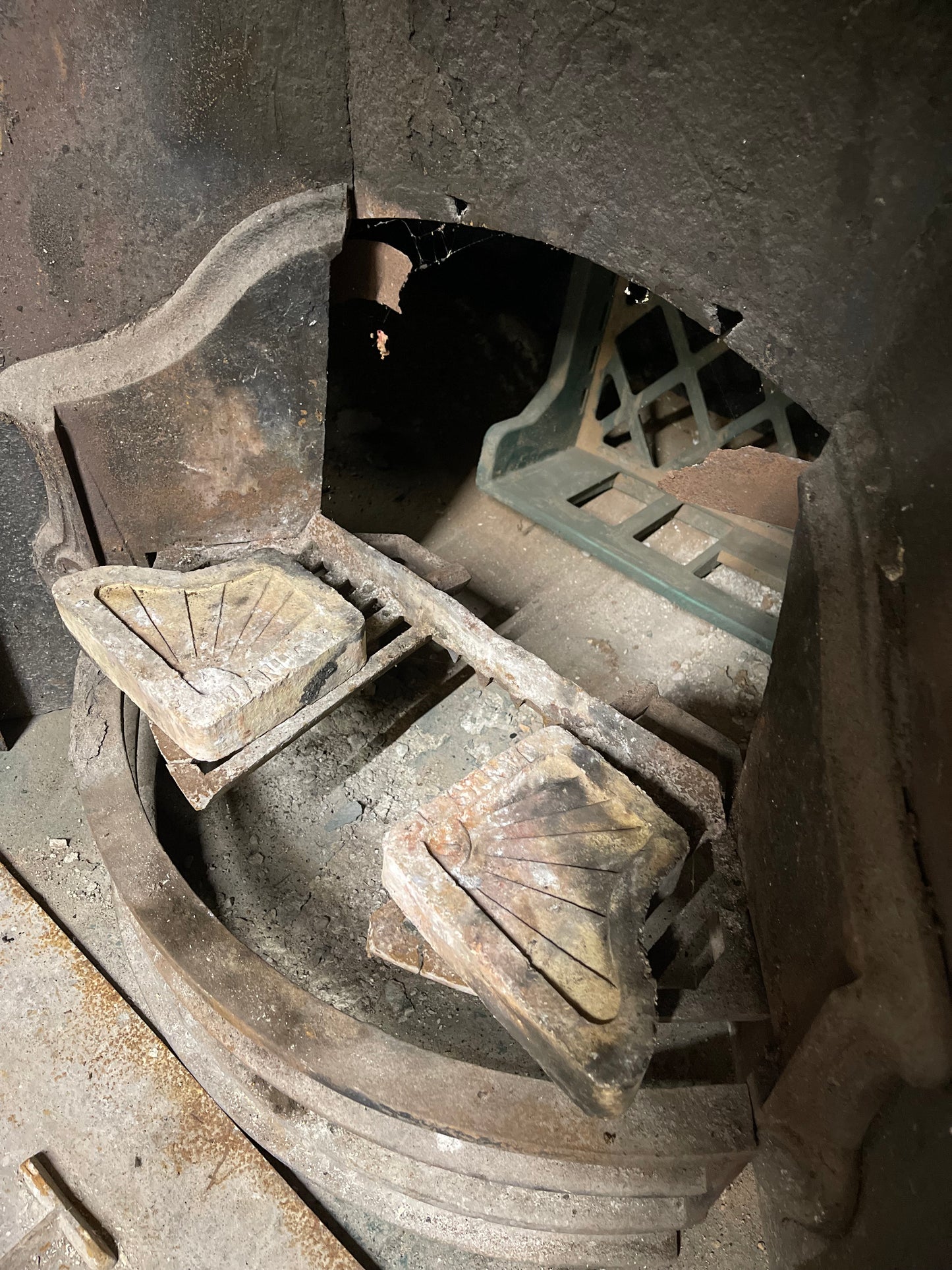 Old cast iron fireplace with decorative fender