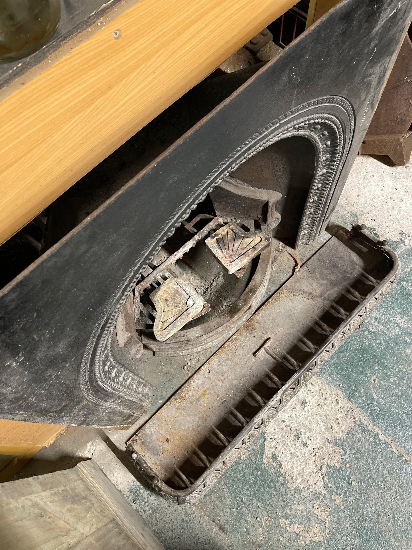 Old cast iron fireplace with decorative fender