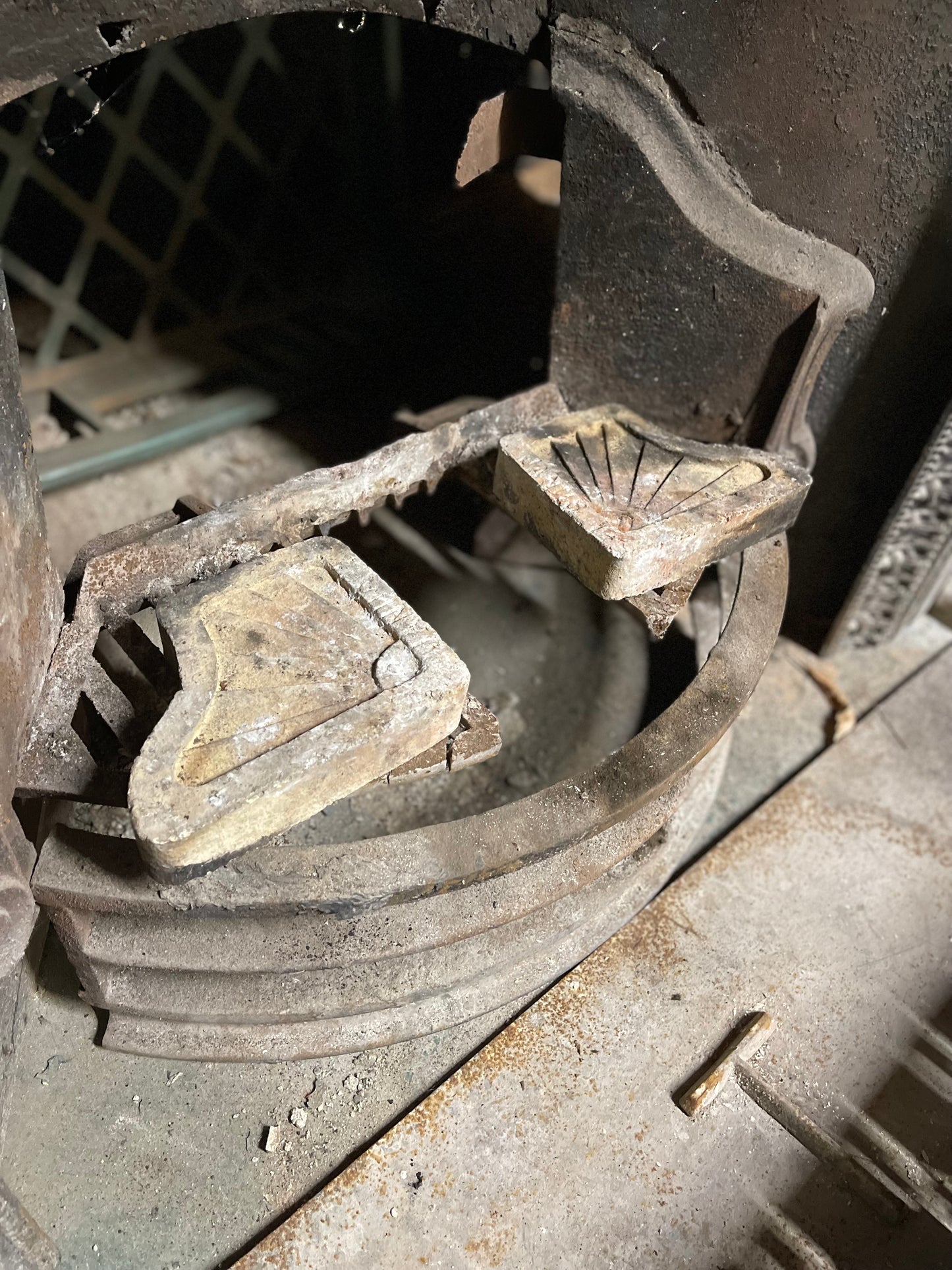 Old cast iron fireplace with decorative fender