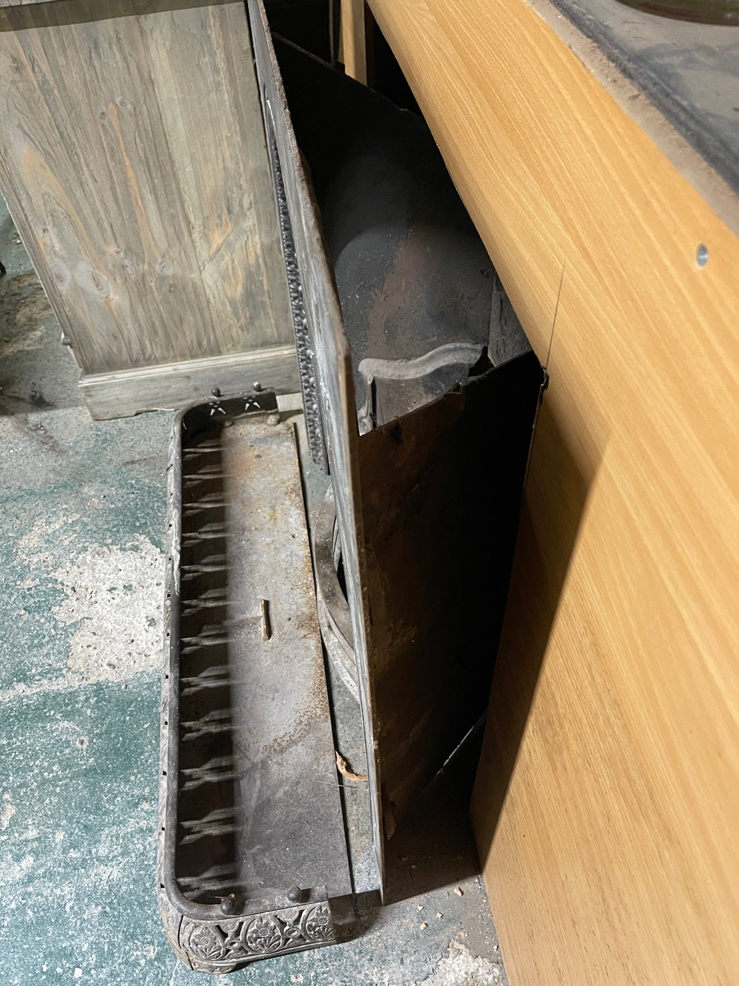 Old cast iron fireplace with decorative fender