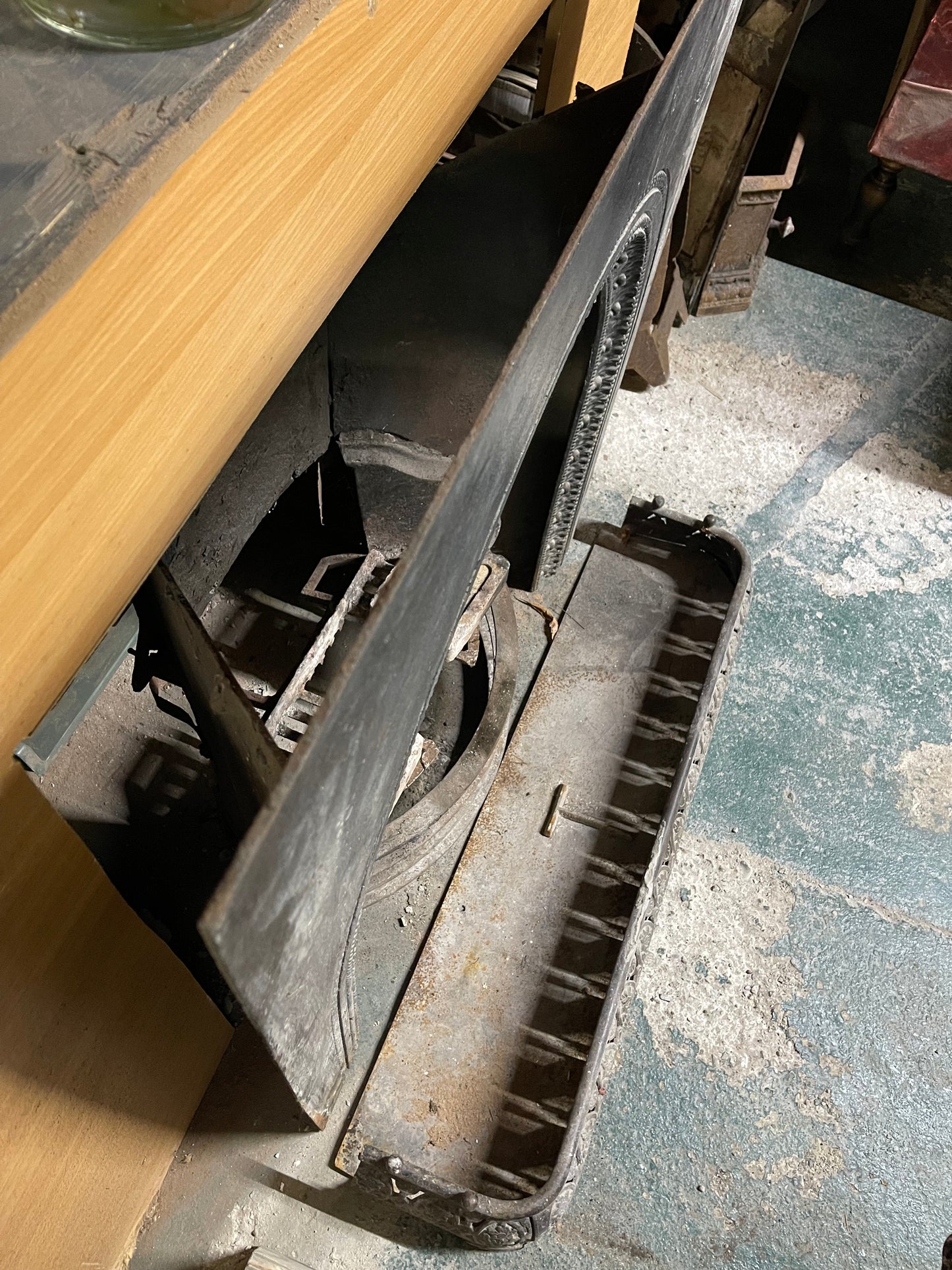 Old cast iron fireplace with decorative fender