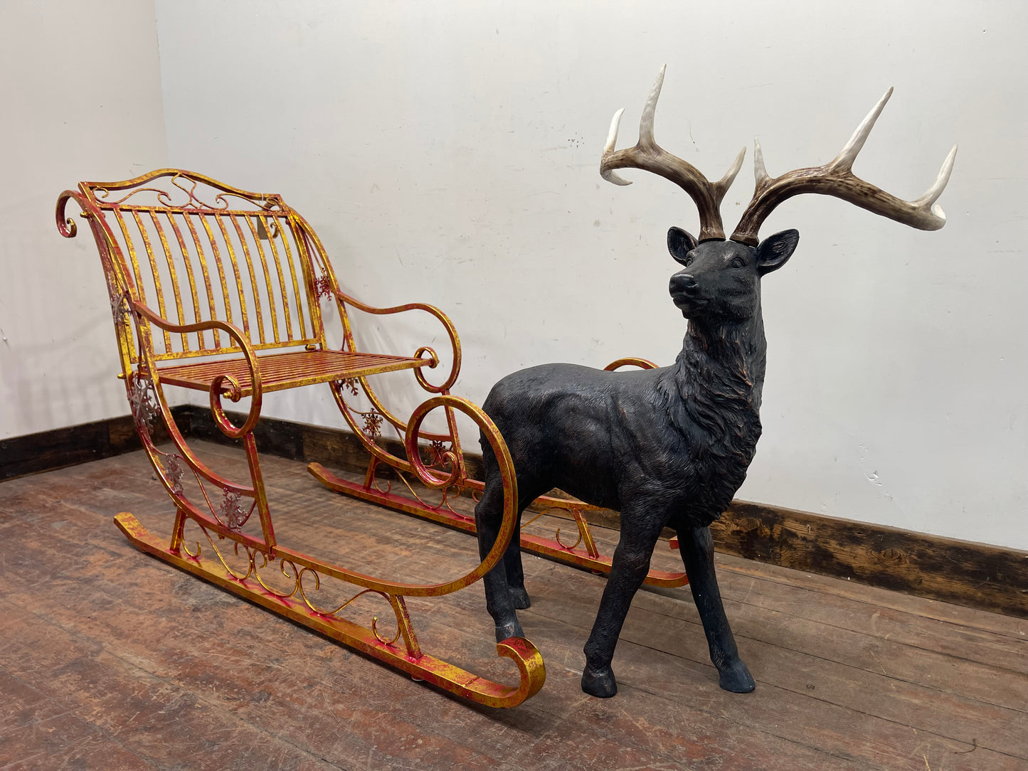 Red and gold Christmas sleigh including reindeer figure