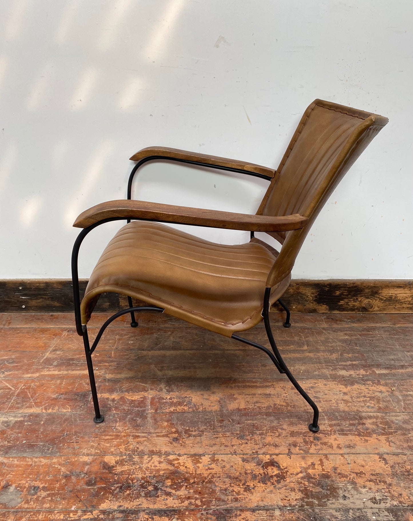 Reclined tan / brown leather armchair