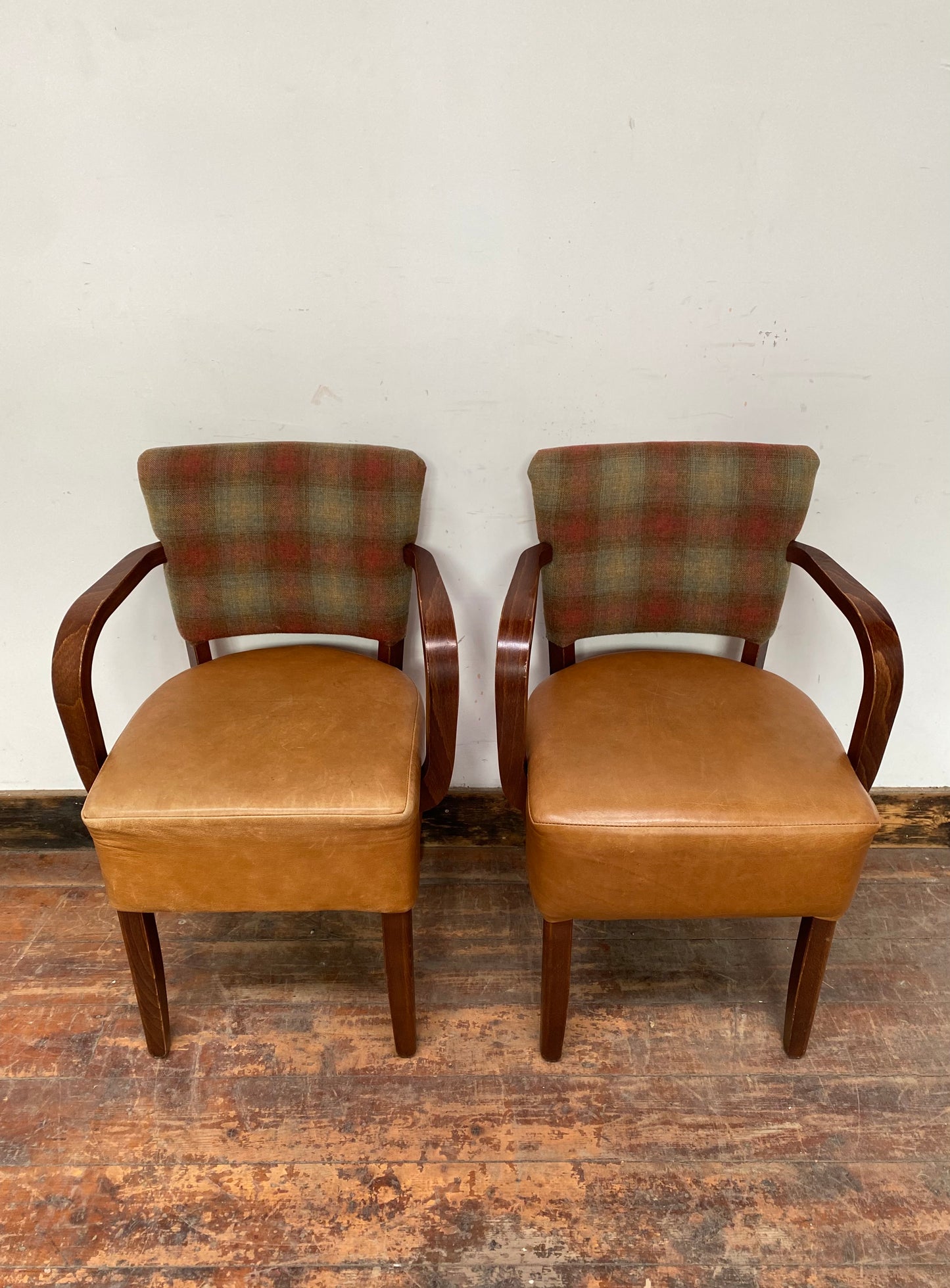 Pair of tan leather and check fabric chairs