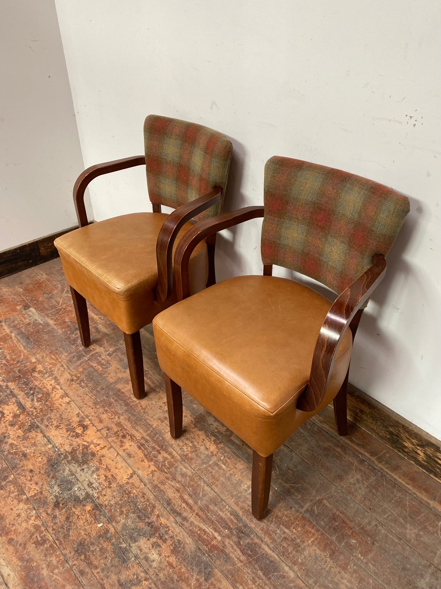 Pair of tan leather and check fabric chairs