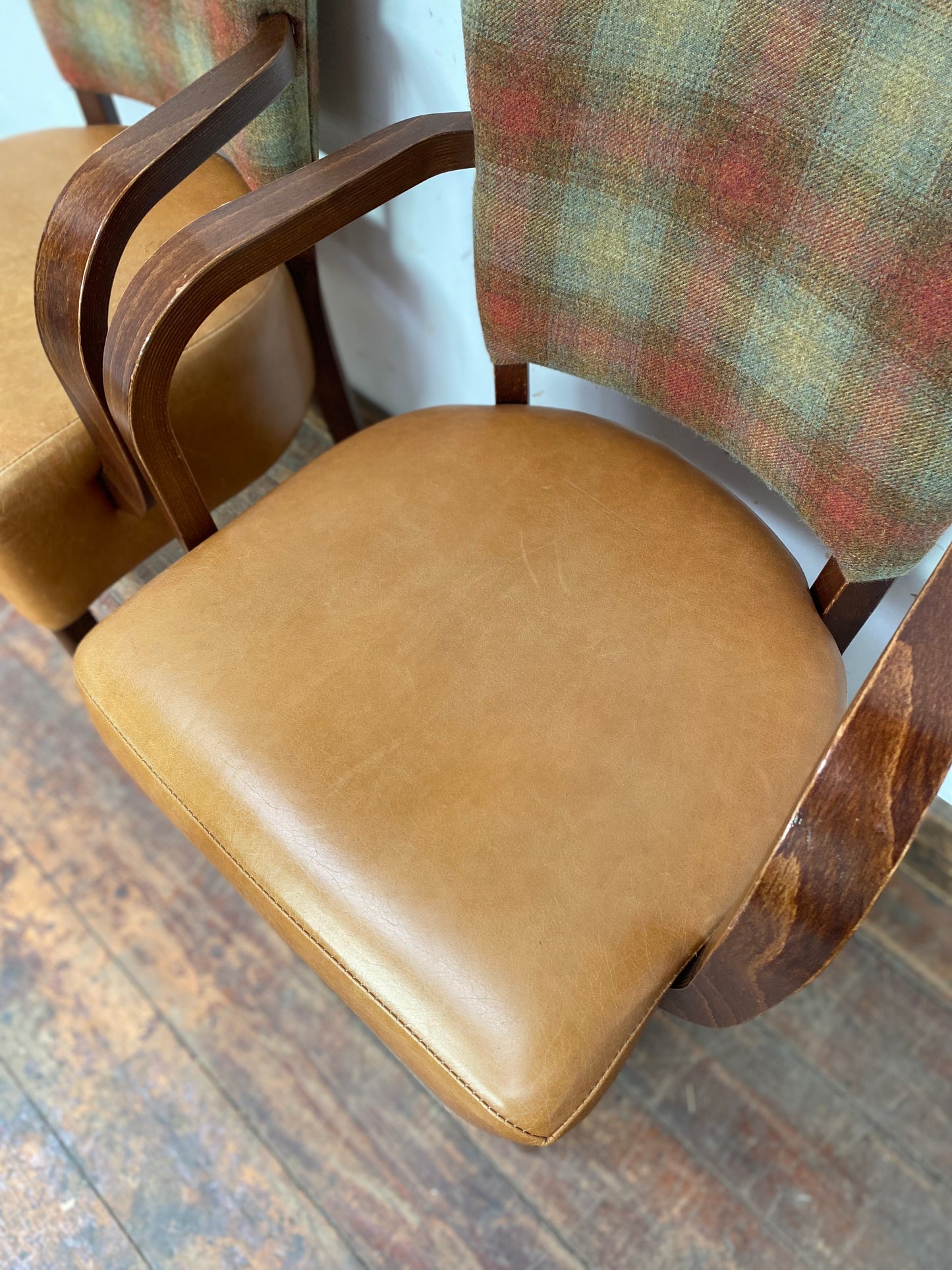Pair of tan leather and check fabric chairs