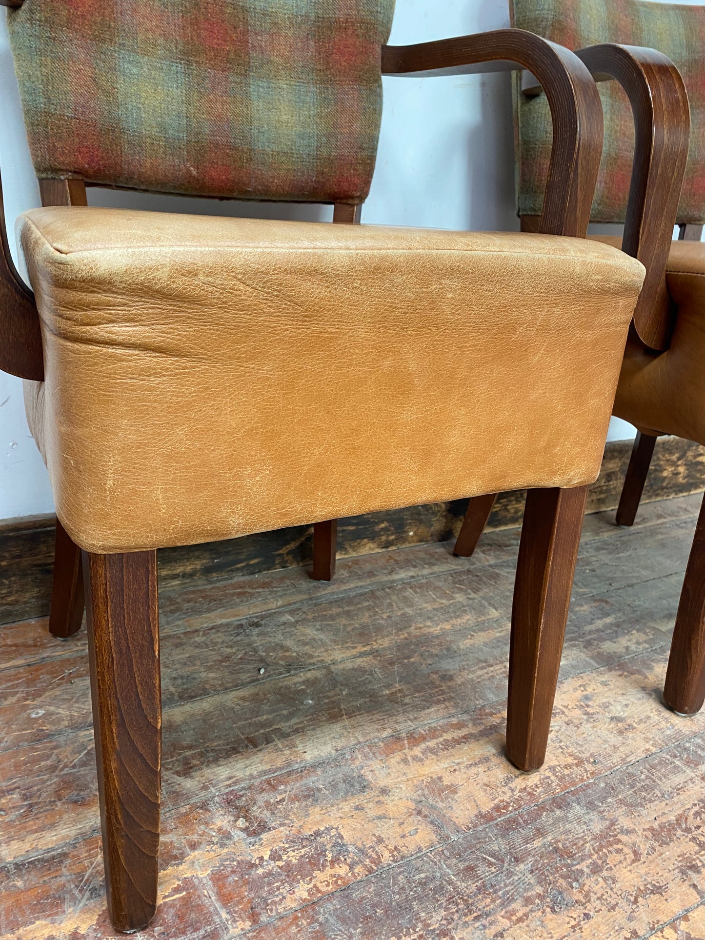 Pair of tan leather and check fabric chairs