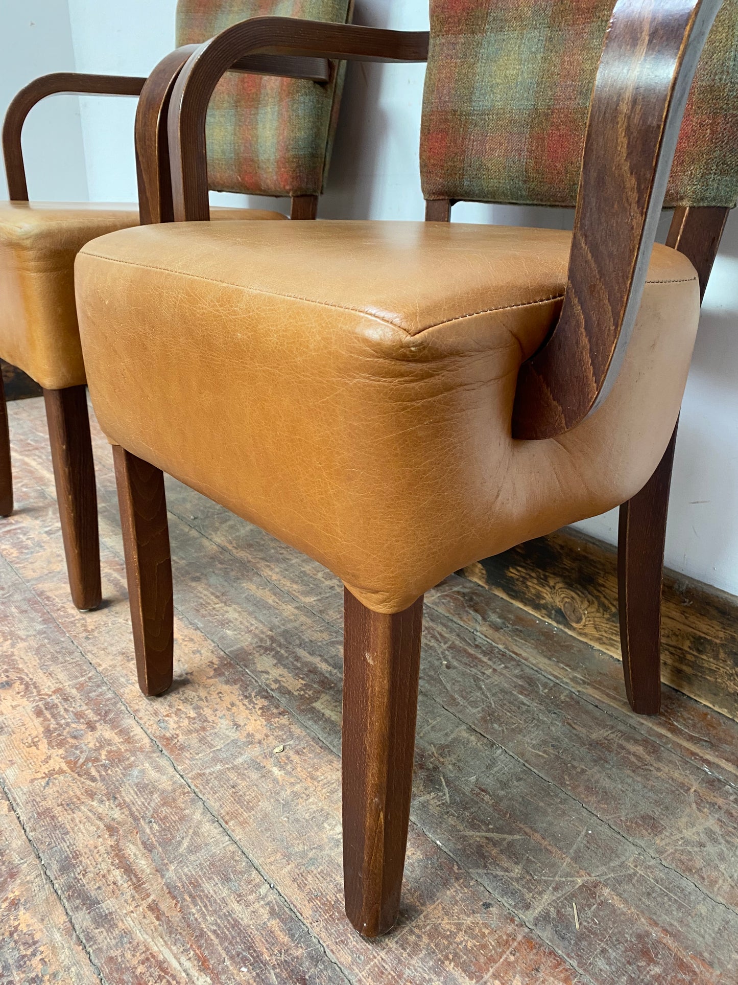 Pair of tan leather and check fabric chairs