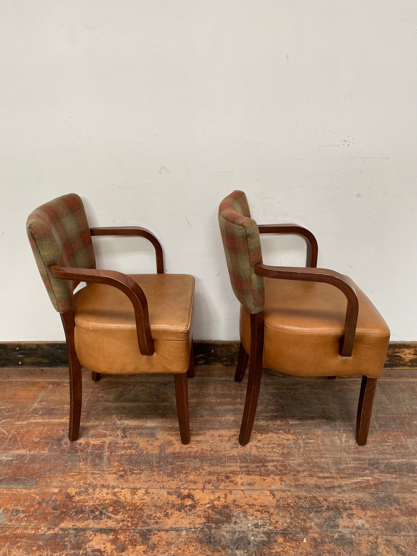 Pair of tan leather and check fabric chairs
