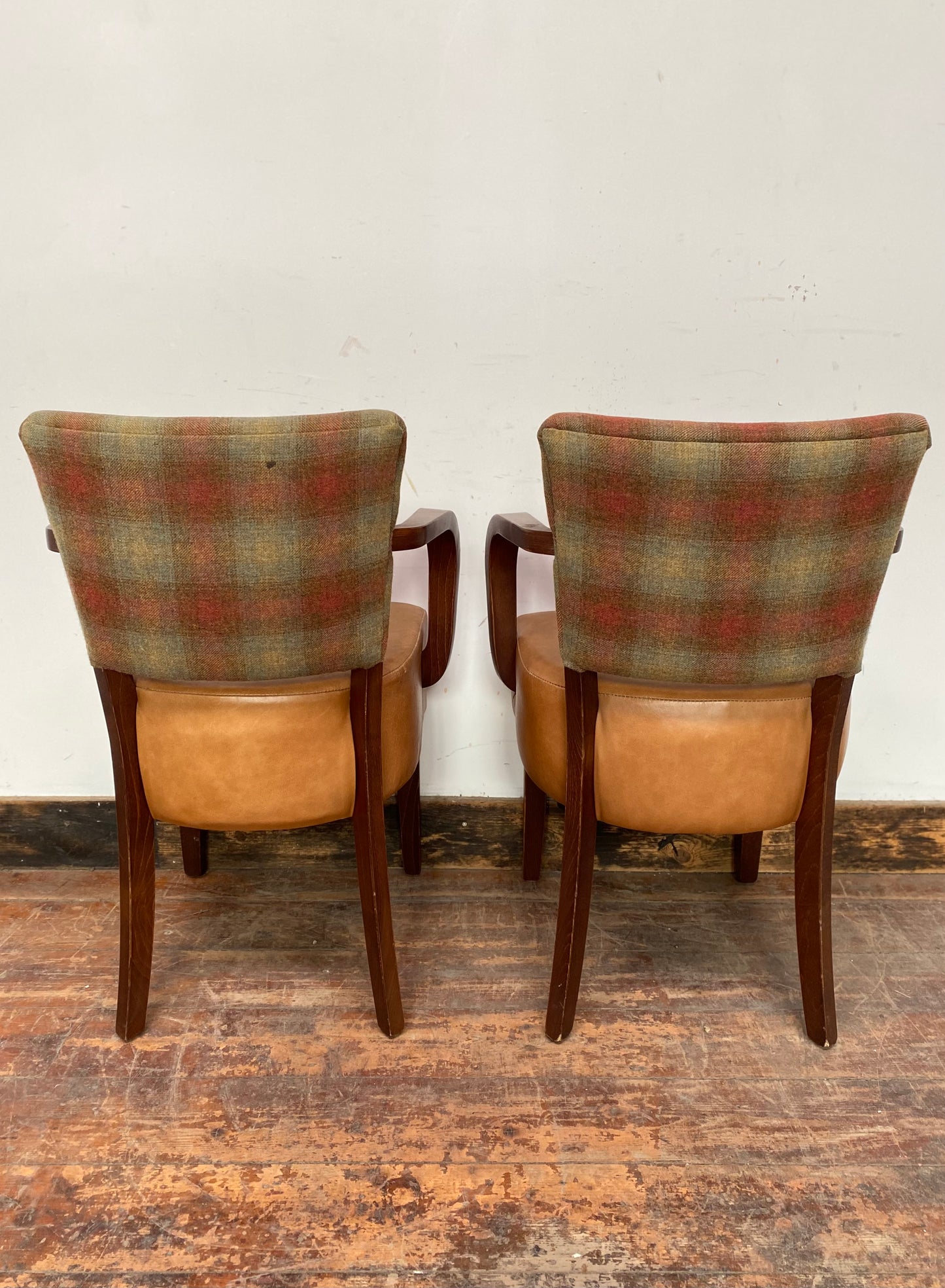 Pair of tan leather and check fabric chairs