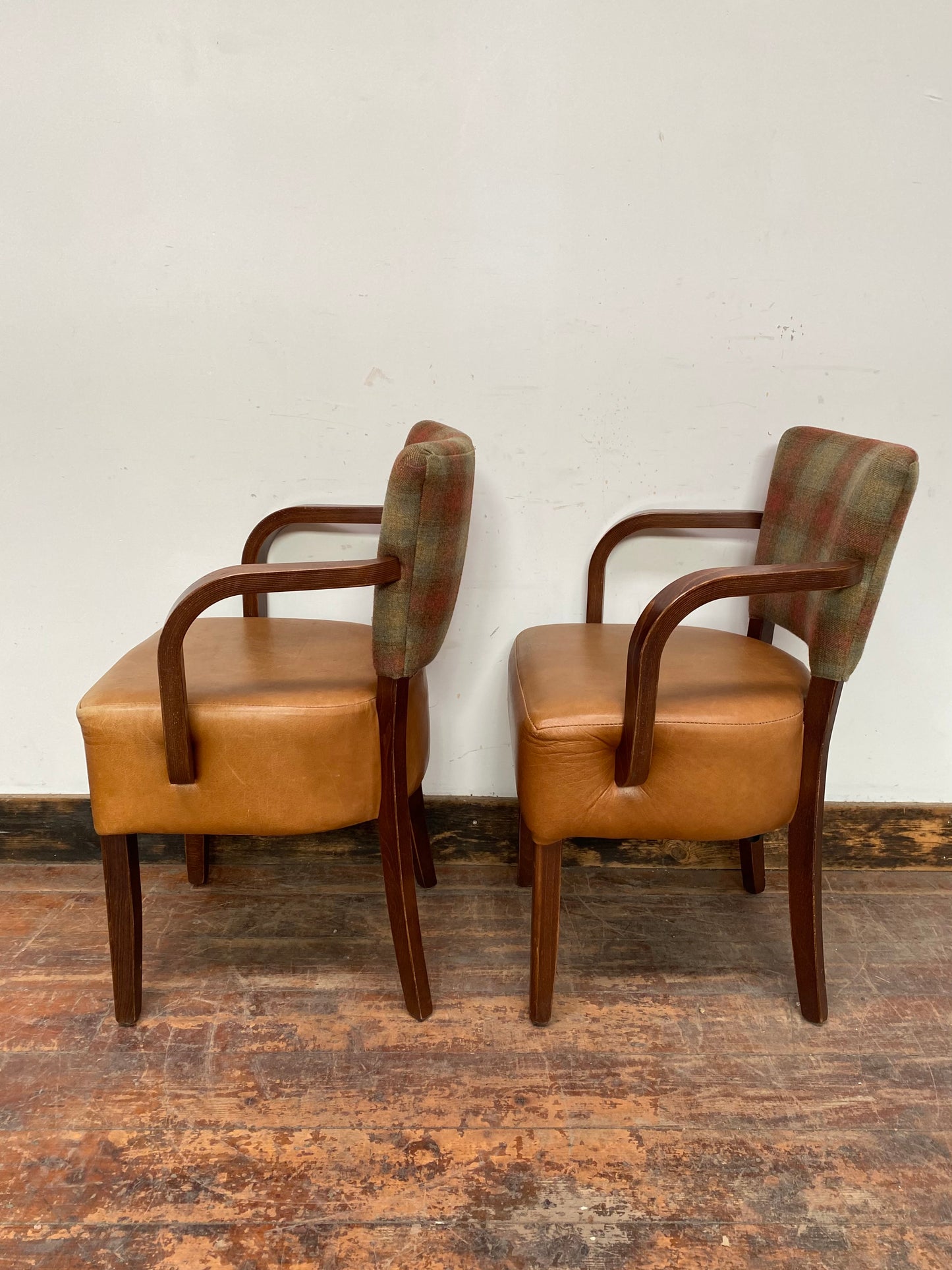 Pair of tan leather and check fabric chairs