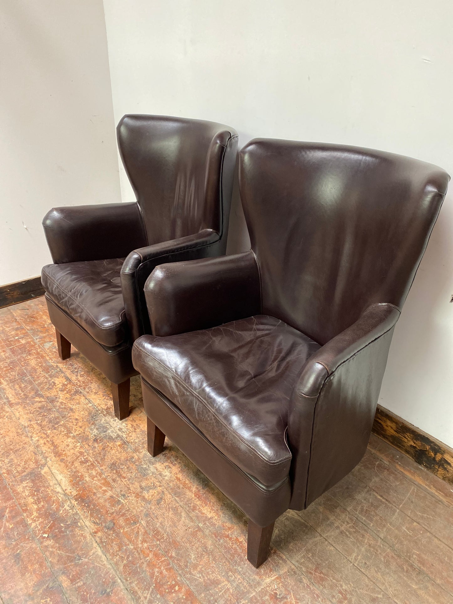 Pair of matching leather wingback armchairs