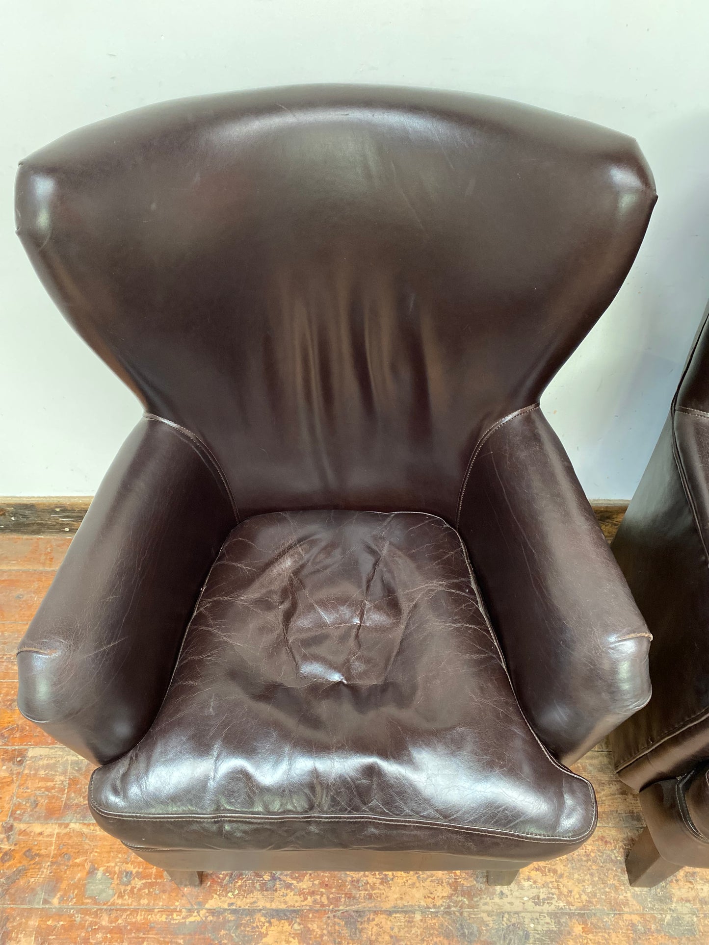 Pair of matching leather wingback armchairs