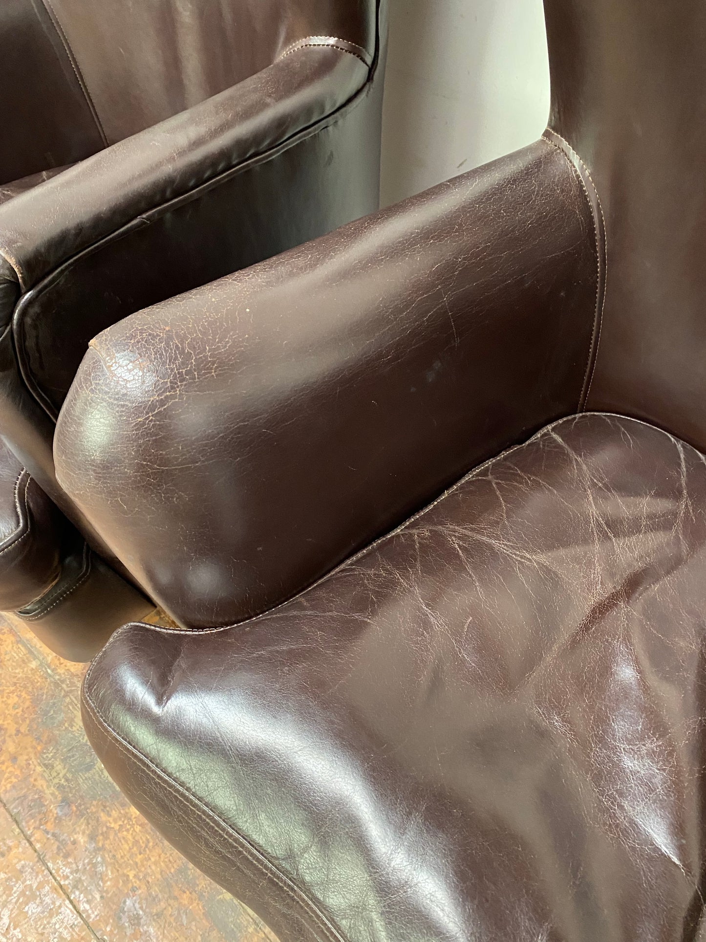 Pair of matching leather wingback armchairs