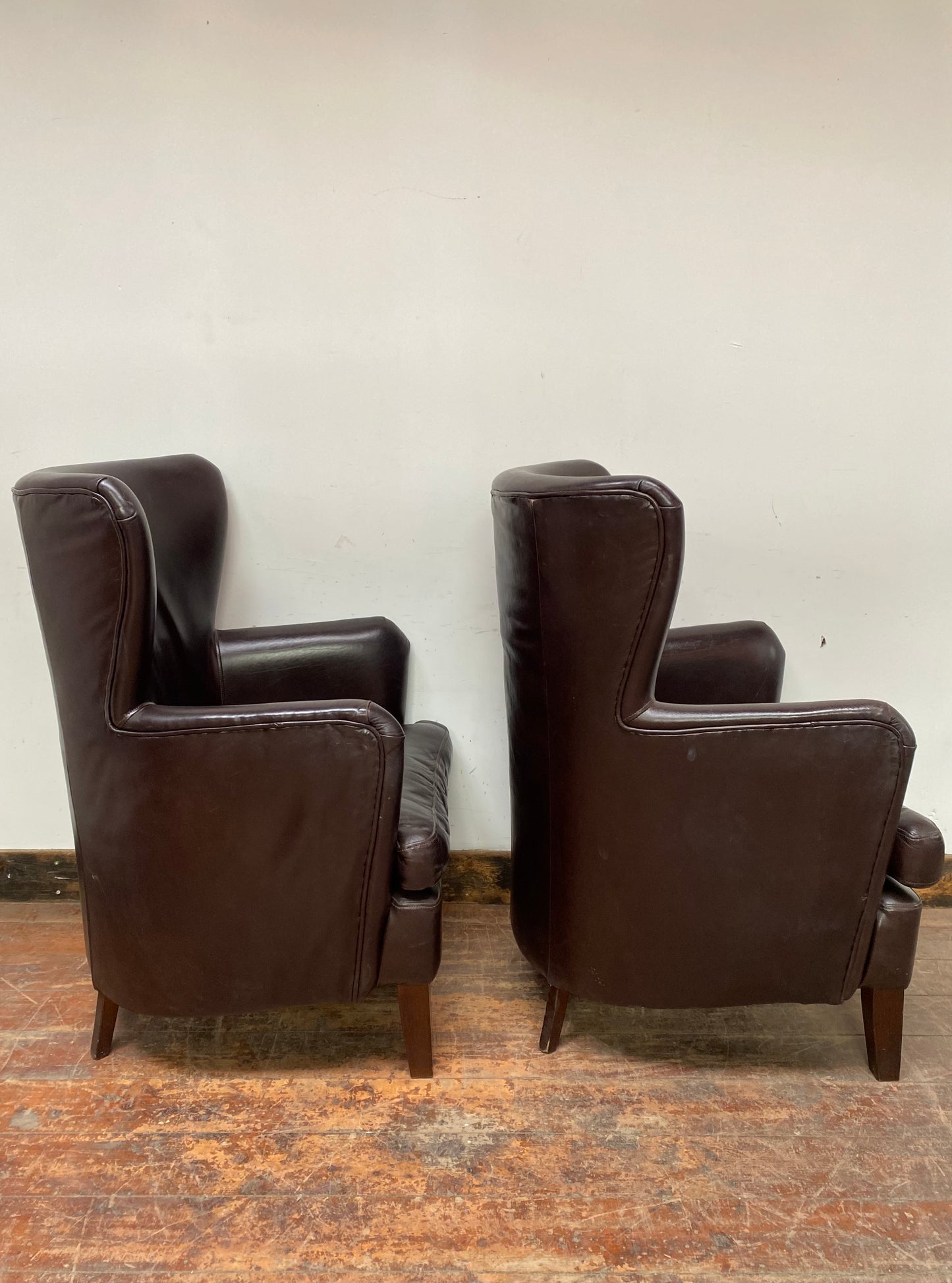 Pair of matching leather wingback armchairs