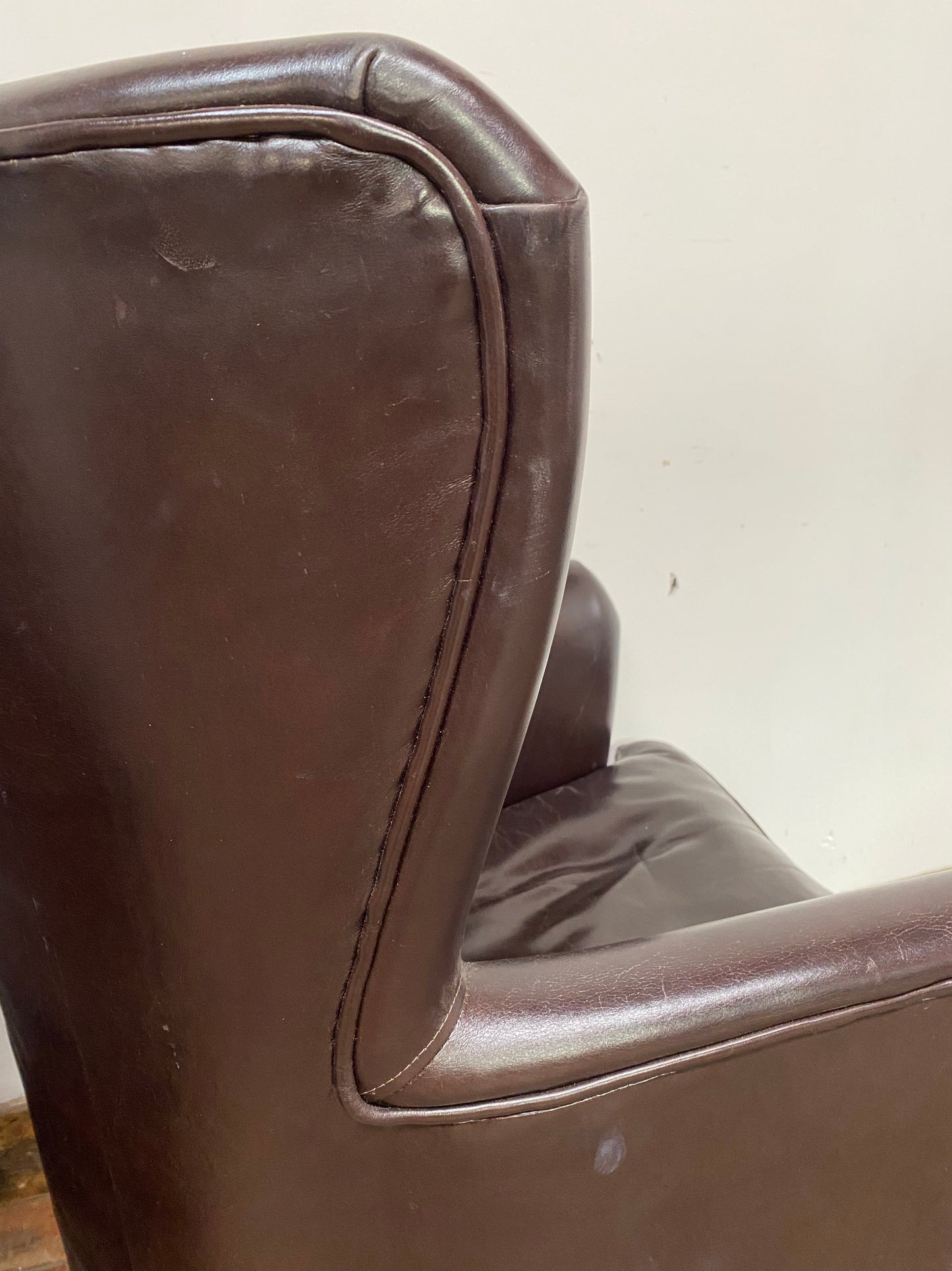 Pair of matching leather wingback armchairs
