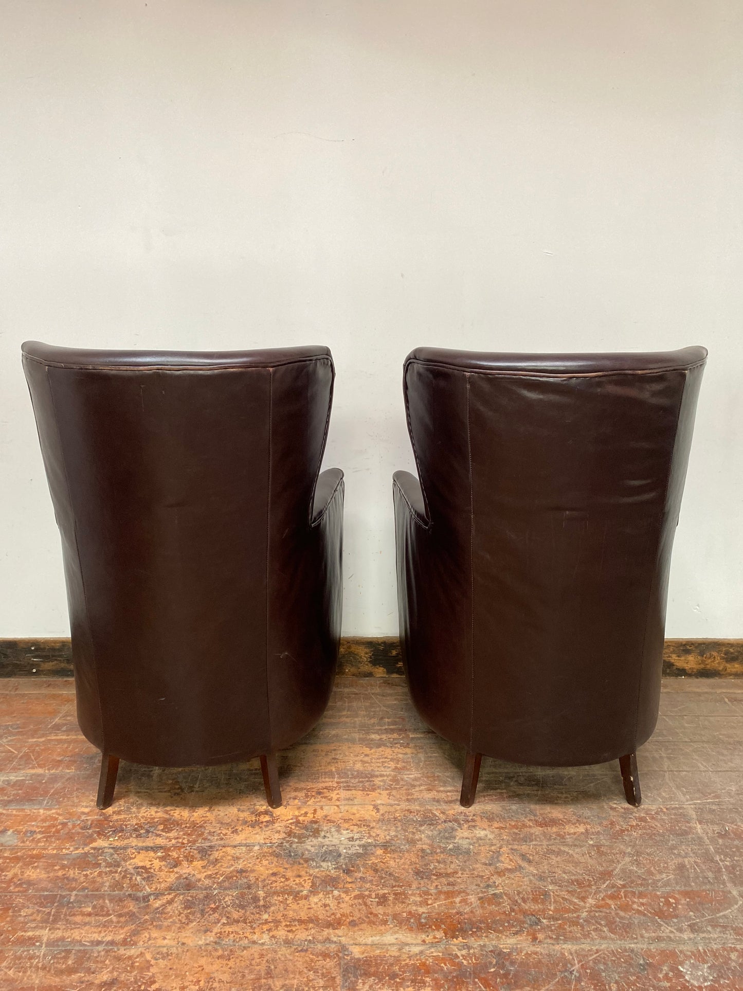 Pair of matching leather wingback armchairs