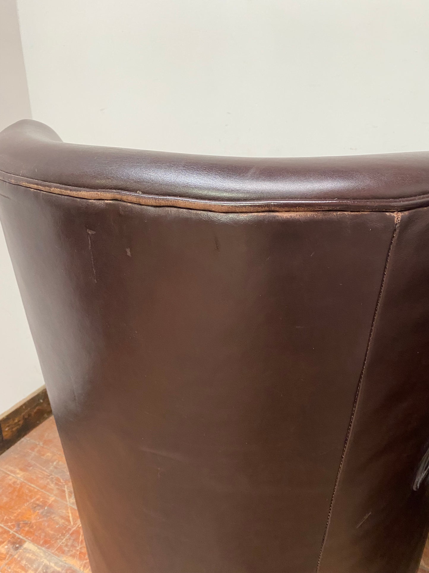 Pair of matching leather wingback armchairs