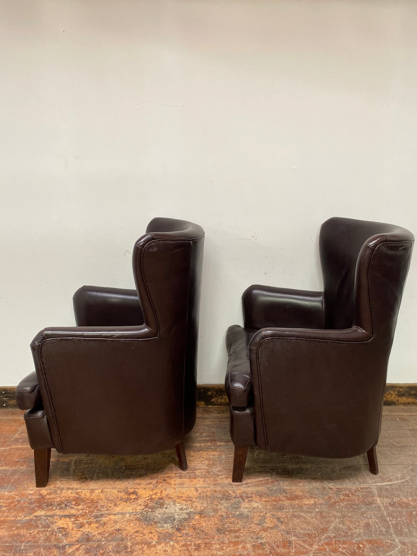 Pair of matching leather wingback armchairs
