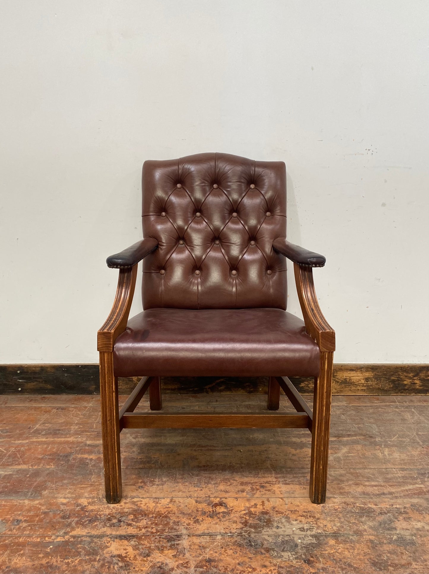 Brown leather armchair with wood frame