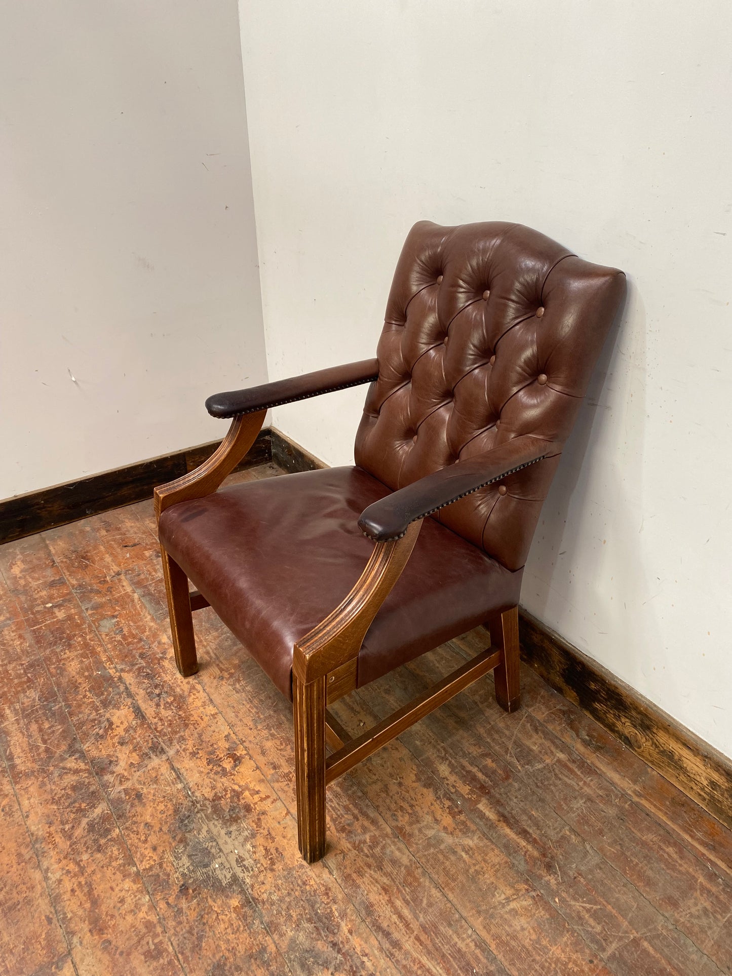 Brown leather armchair with wood frame