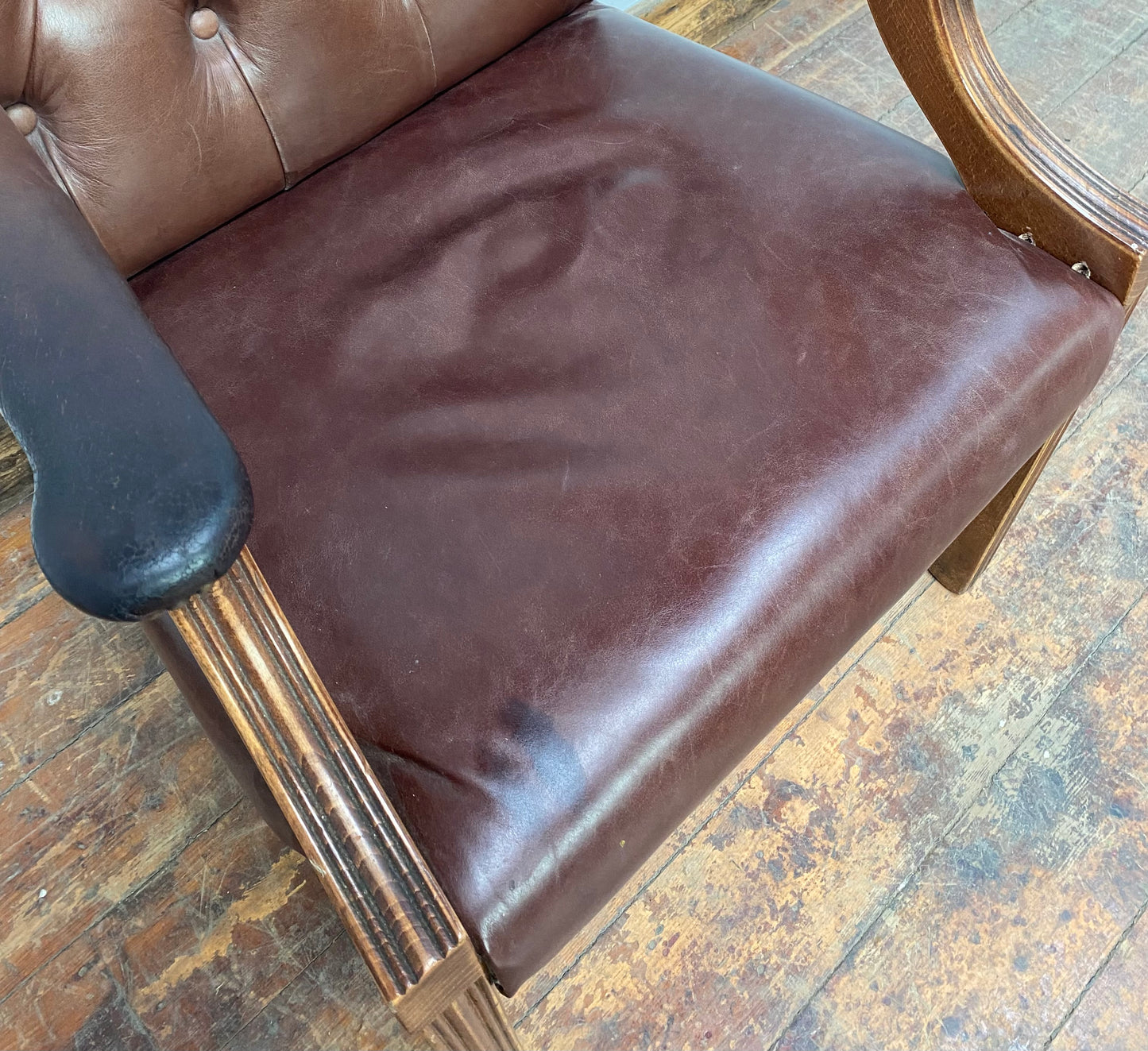 Brown leather armchair with wood frame