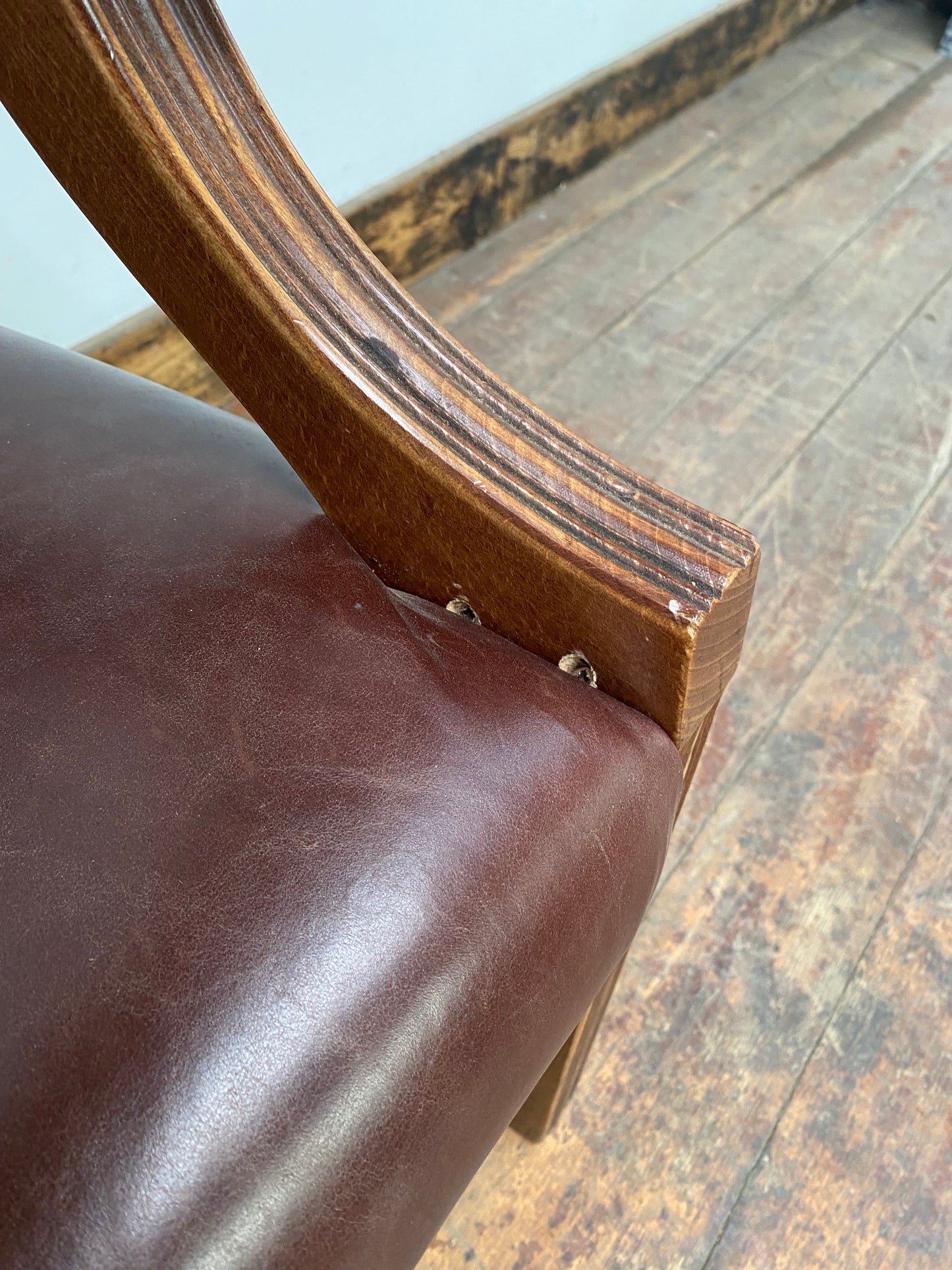Brown leather armchair with wood frame