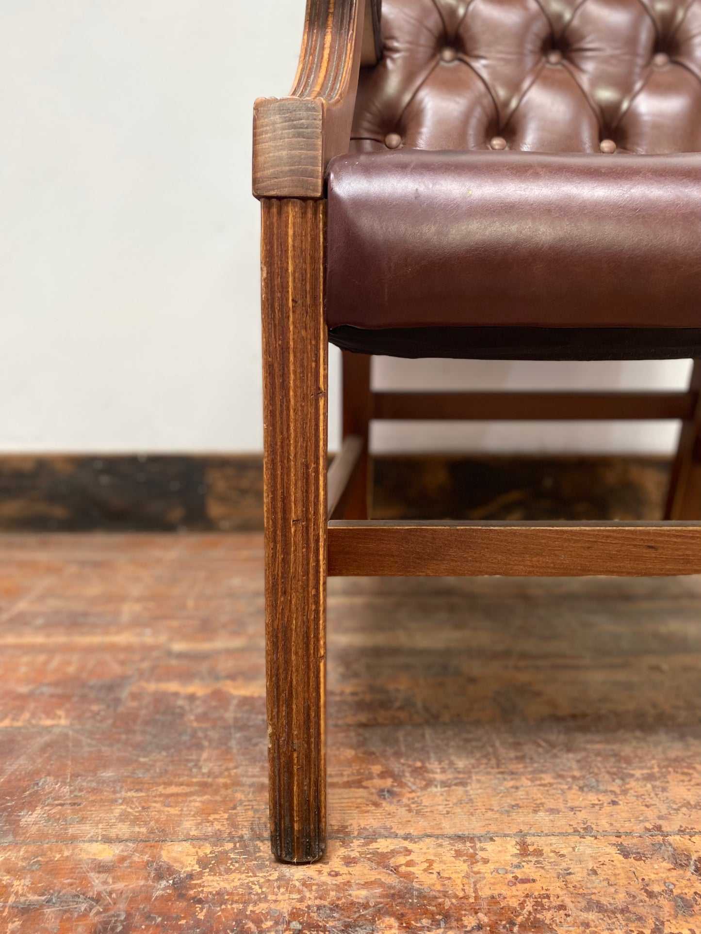 Brown leather armchair with wood frame