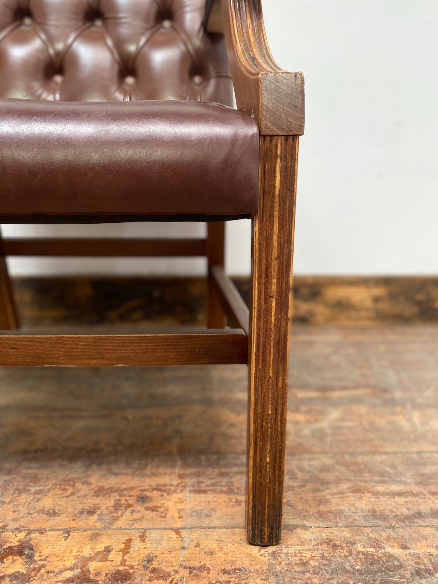 Brown leather armchair with wood frame
