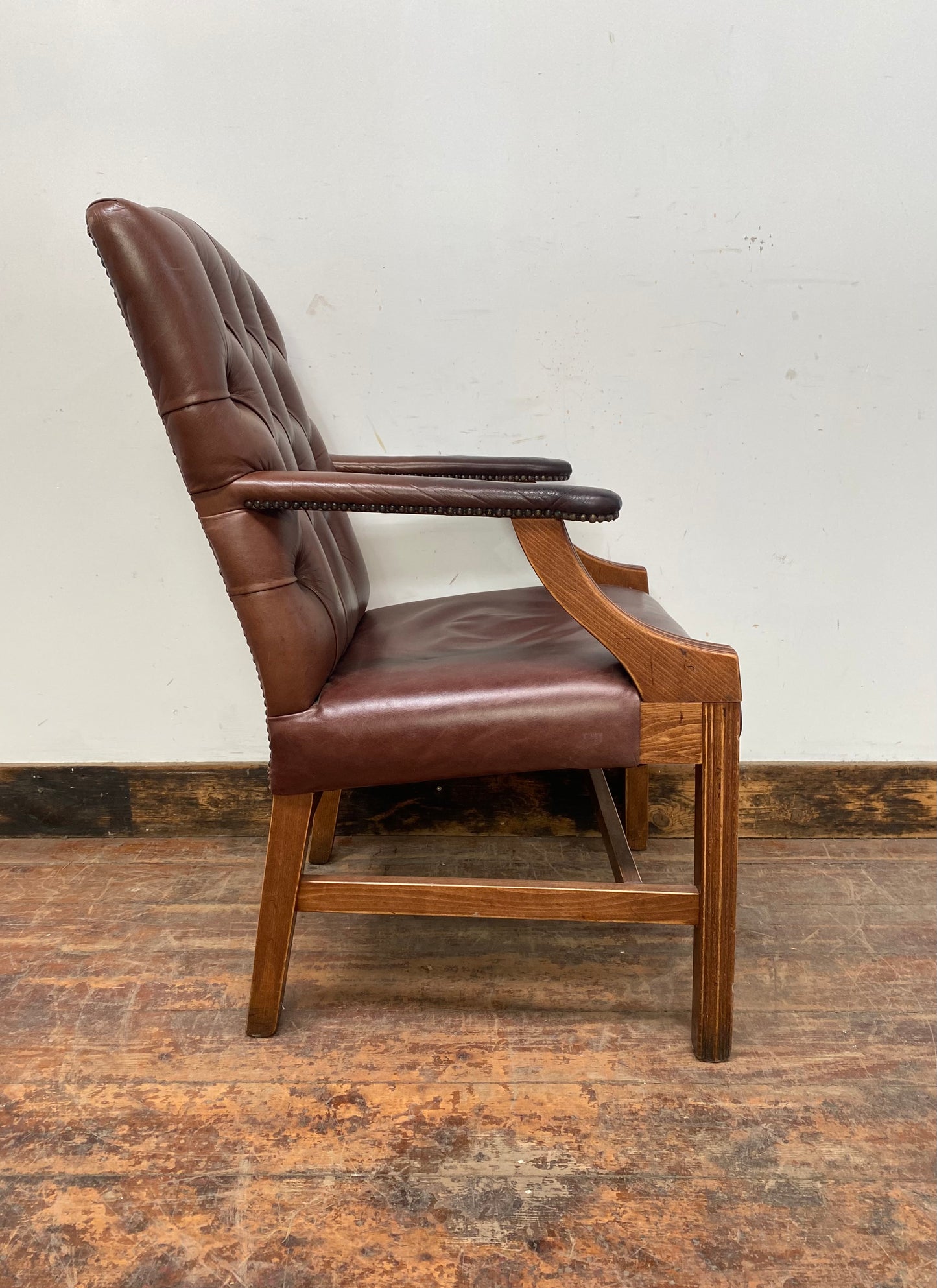 Brown leather armchair with wood frame